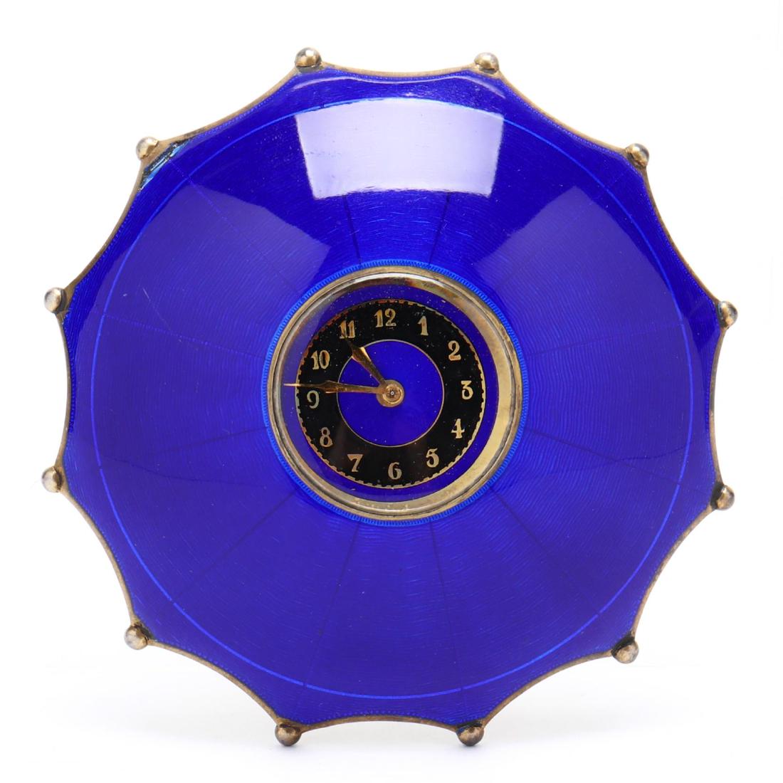 An Art Deco Swiss Guilloche Enameled .935 Silver Gilt: An Art Deco Swiss Guilloche Enameled .935 Silver Gilt Desk Clockwith French import marks, cobalt blue guilloche enameling, domed form with twelve points, black and gold dials. 3 3/8 in. diameter 3.45