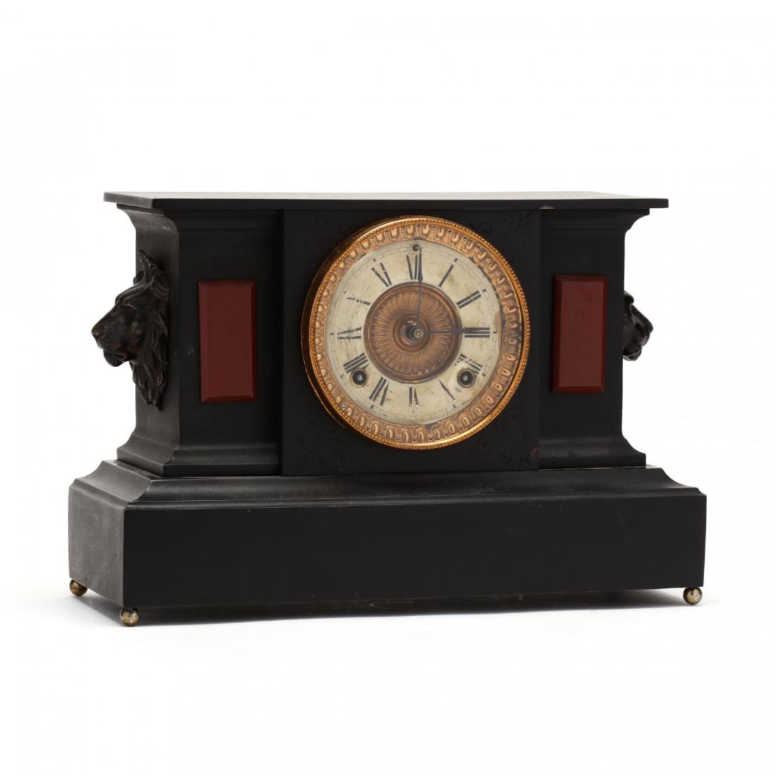 Ansonia Sheet Iron Mantel Clock: Ansonia Sheet Iron Mantel Clock late 19th century, the case painted to simulate slate with jasper panels; a spelter lion mask appliquÃ© to either side; time and strike brass movement signed "Ansonia