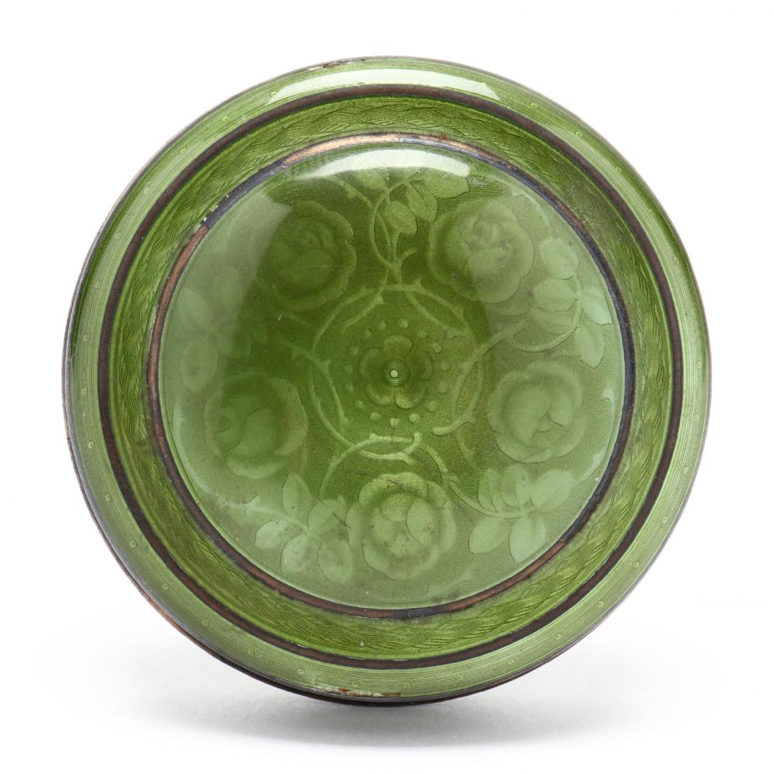 A Guilloche Enameled Sterling Silver Pill Box: A Guilloche Enameled Sterling Silver Pill Box with Russian import marks for St. Petersburg, circular form, parcel gilt, the removable cover with floral and foliate design, spring green enamel. 2 1/8 i