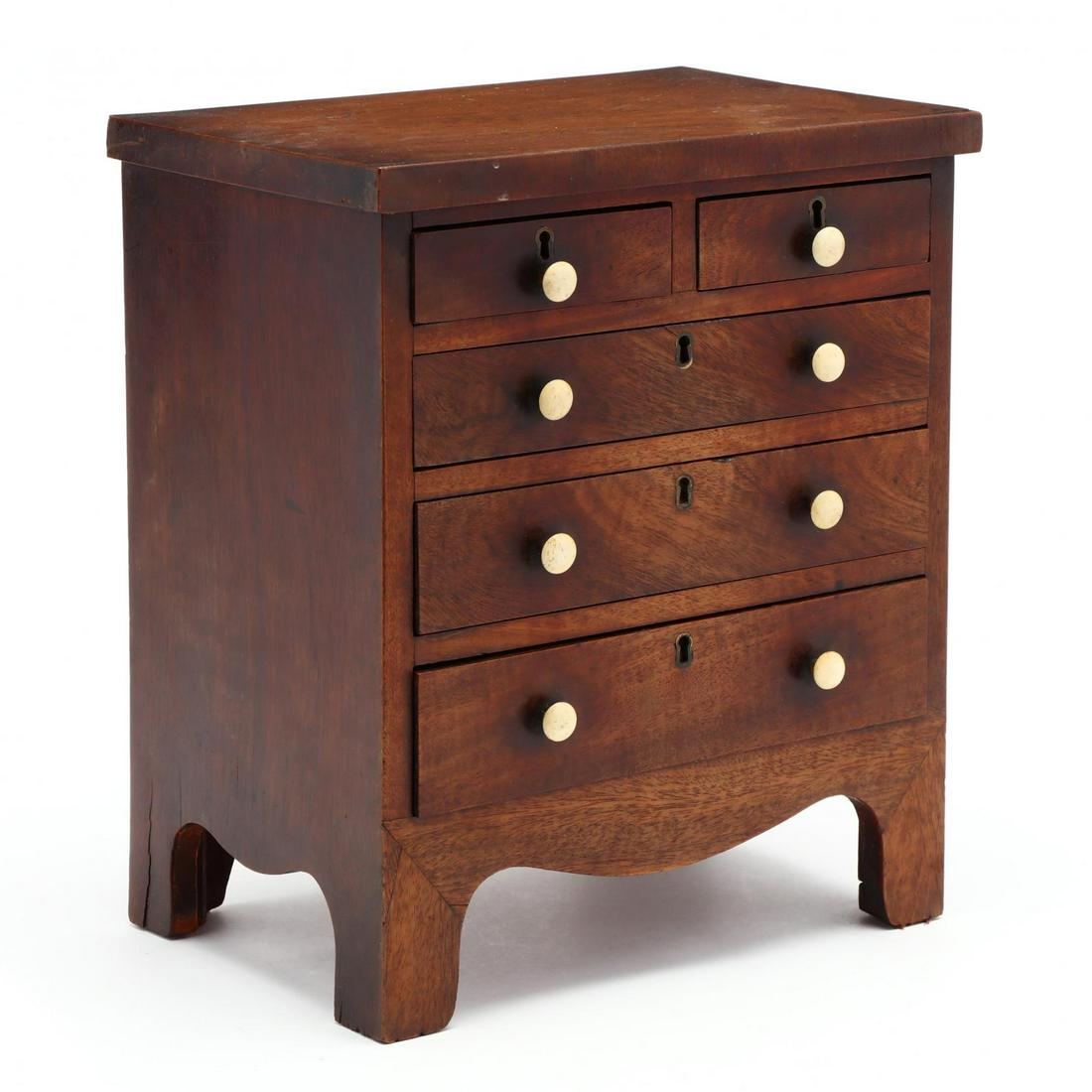 George III Mahogany Child's Chest of Drawers: George III Mahogany Child's Chest of Drawers early 19th century, mahogany veneer, pine secondary, top with applied vertical veneered edge, nice form with two over three graduated drawers, scalloped sk