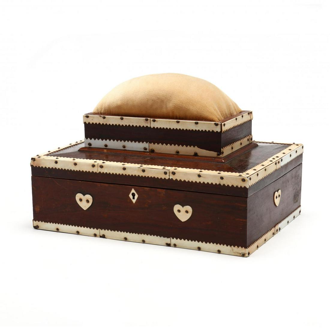 Sailor Art Scrimshaw Sewing Box: Sailor Art Scrimshaw Sewing Box 19th century, rosewood veneered case with scrimshaw mounts, raised velvet cushion, the front with two heart plaques, paper lined interior. 8 x 12 x 8.5 in. From the Col