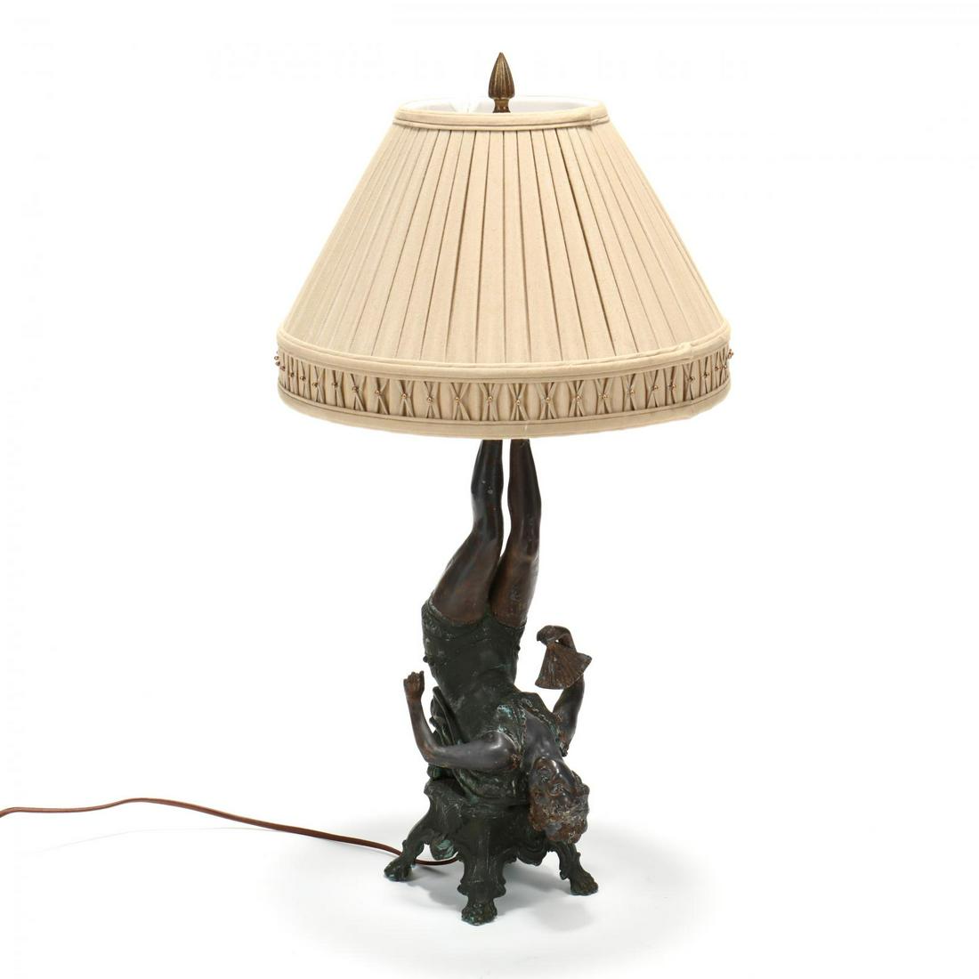 Vintage Figural Table Lamp: Vintage Figural Table Lampearly 20th century, cast and painted spelter in the form of an upside down performer on a claw foot ottoman, with later pleated shade. HOA 27 in. Southern Private Collection