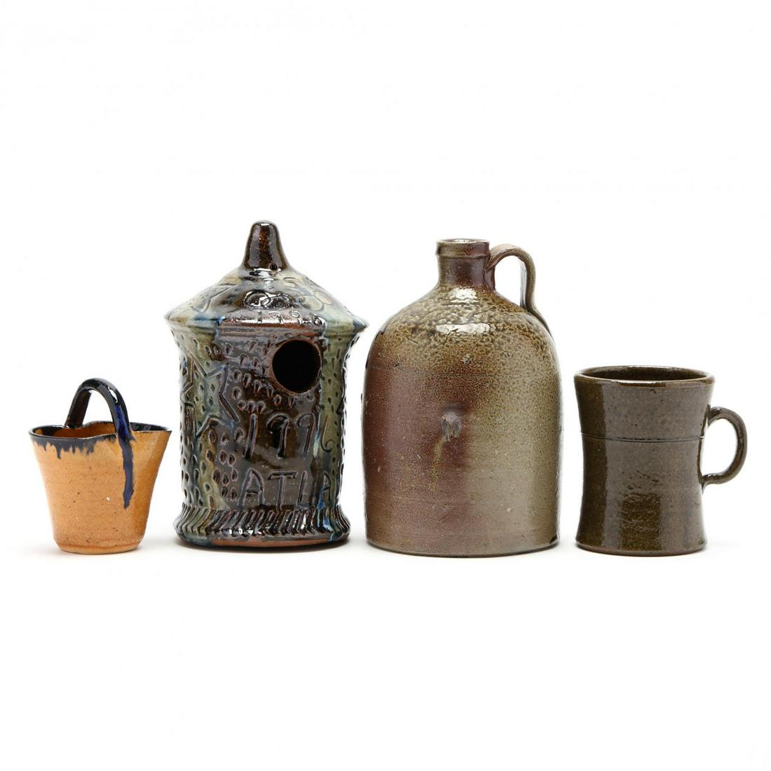 Four Pieces of Southern Pottery: Four Pieces of Southern Pottery including a 19th century NC salt glazed jug; a Grace Hewell (GA) folk art birdhouse commemorating the 1996 Olympics; a David Meaders (GA) large mug; and a cobalt glazed
