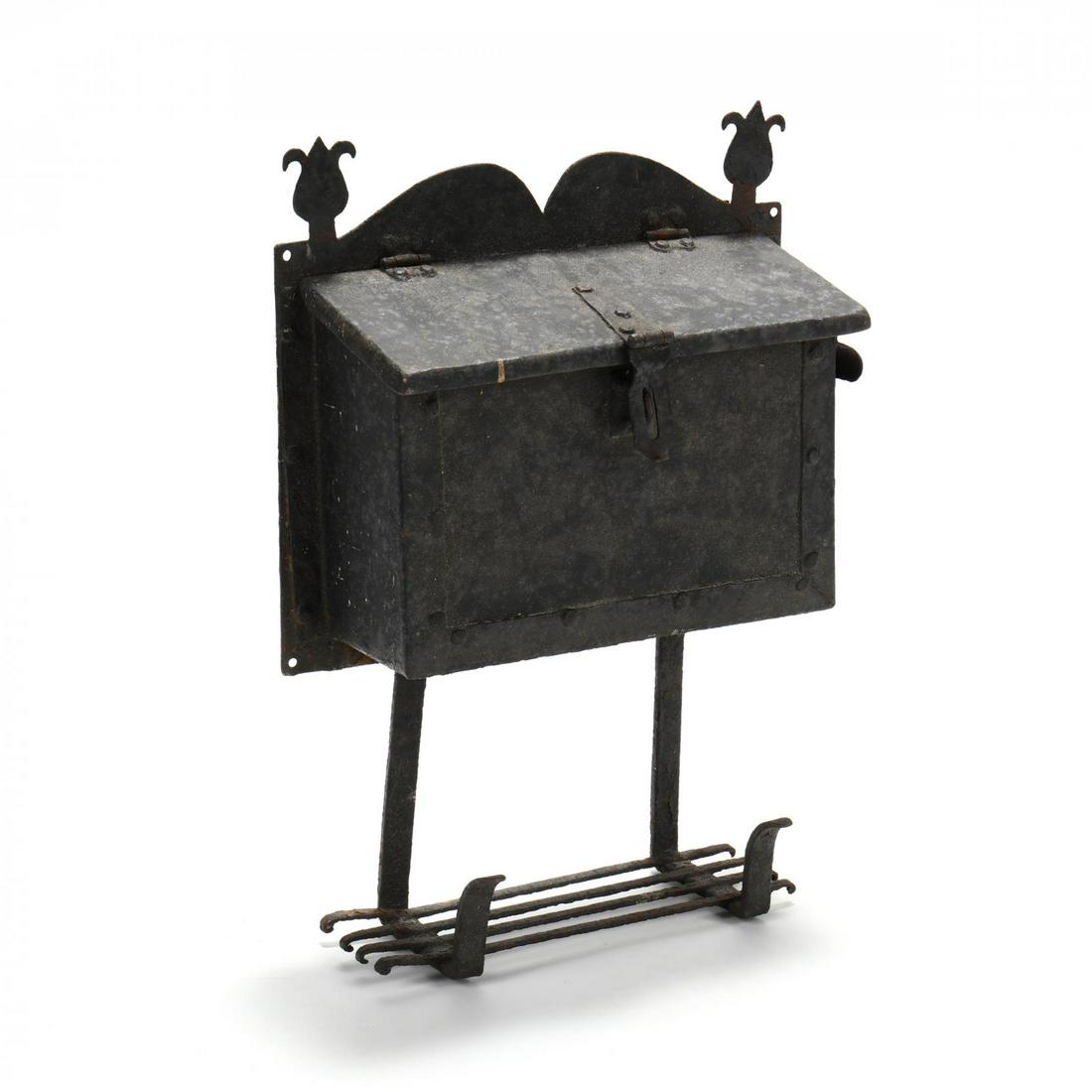 Vintage Arts and Crafts Iron Mailbox: Vintage Arts and Crafts Iron Mailbox early 20th century, black painted iron featuring tulip finials, hinged slant lid, box with slot to right side, lower newspaper shelf, unmarked. 20 x 15 x 5 in. Sou