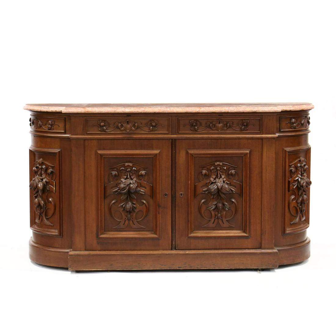 An American Renaissance Revival Carved Walnut and: An American Renaissance Revival Carved Walnut and Marble Top Sideboard circa 1870, walnut, white pine secondary, original rouge marble top with molded edge, case with two relief carved drawers over tw
