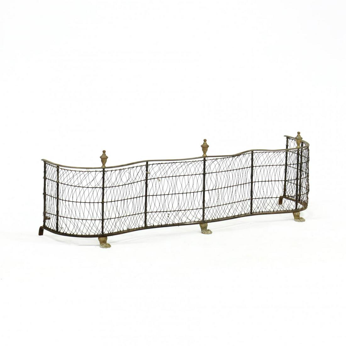 Vintage Wirework Fire Fender: Vintage Wirework Fire Fender early 20th century, brass and iron, serpentine form, with urn form finials, raised on three brass hairy paw feet. 16 x 49 x 13 in. Additional high-resolution photos are av