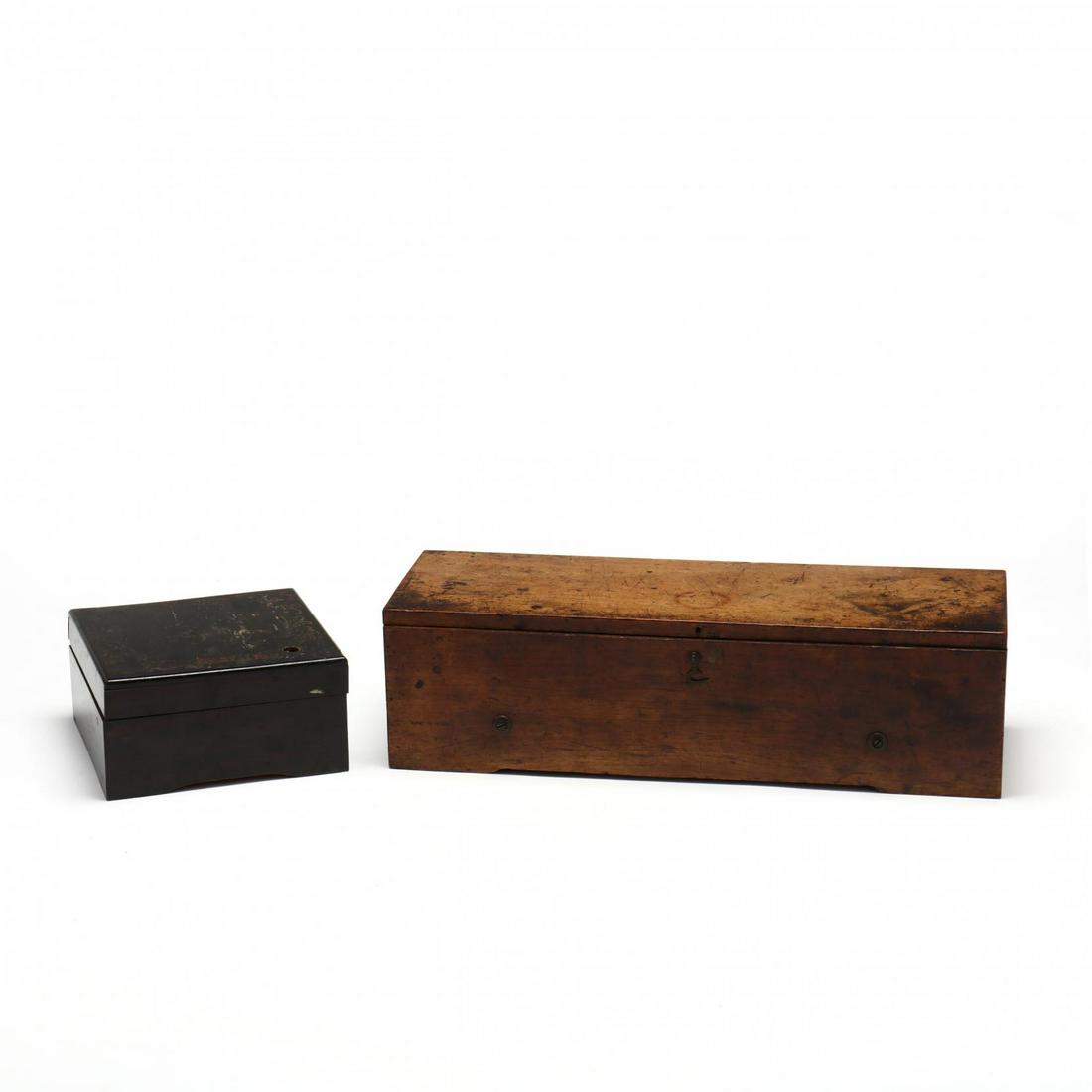 Two Antique Primitive Music Boxes: Two Antique Primitive Music Boxes 19th century, including a walnut rectangular cased box with interior eglomise lid with song titles, left hinged door for stop and key; together with a faux grain pain