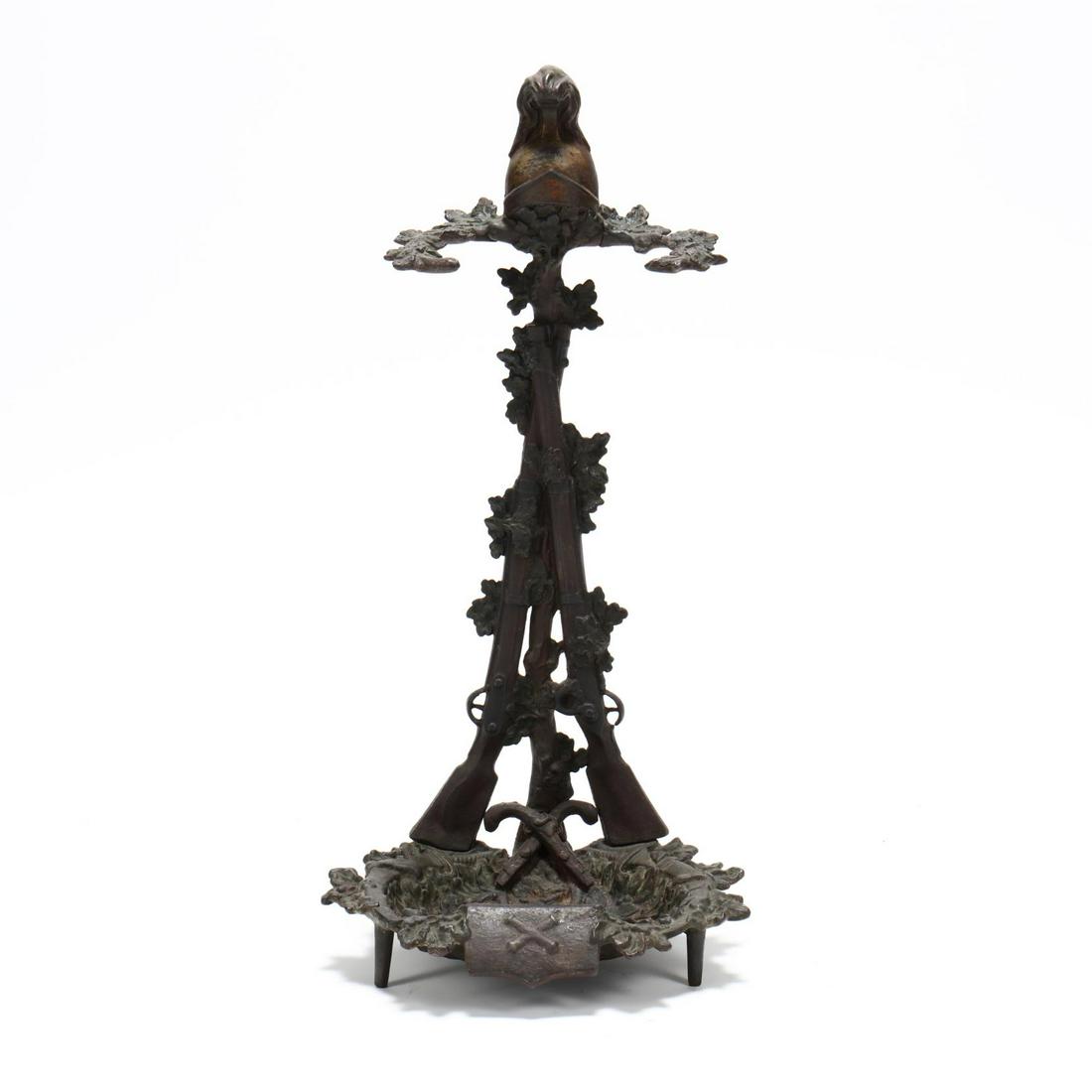 Antique Military Theme Cast iron Umbrella Stand: Antique Military Theme Cast iron Umbrella Stand 19th century, cast iron with painted surface featuring long rifles, swords, pistols, cannons, helmet, and acorn leaves. 26 x 12 x 10 in. From the Collec