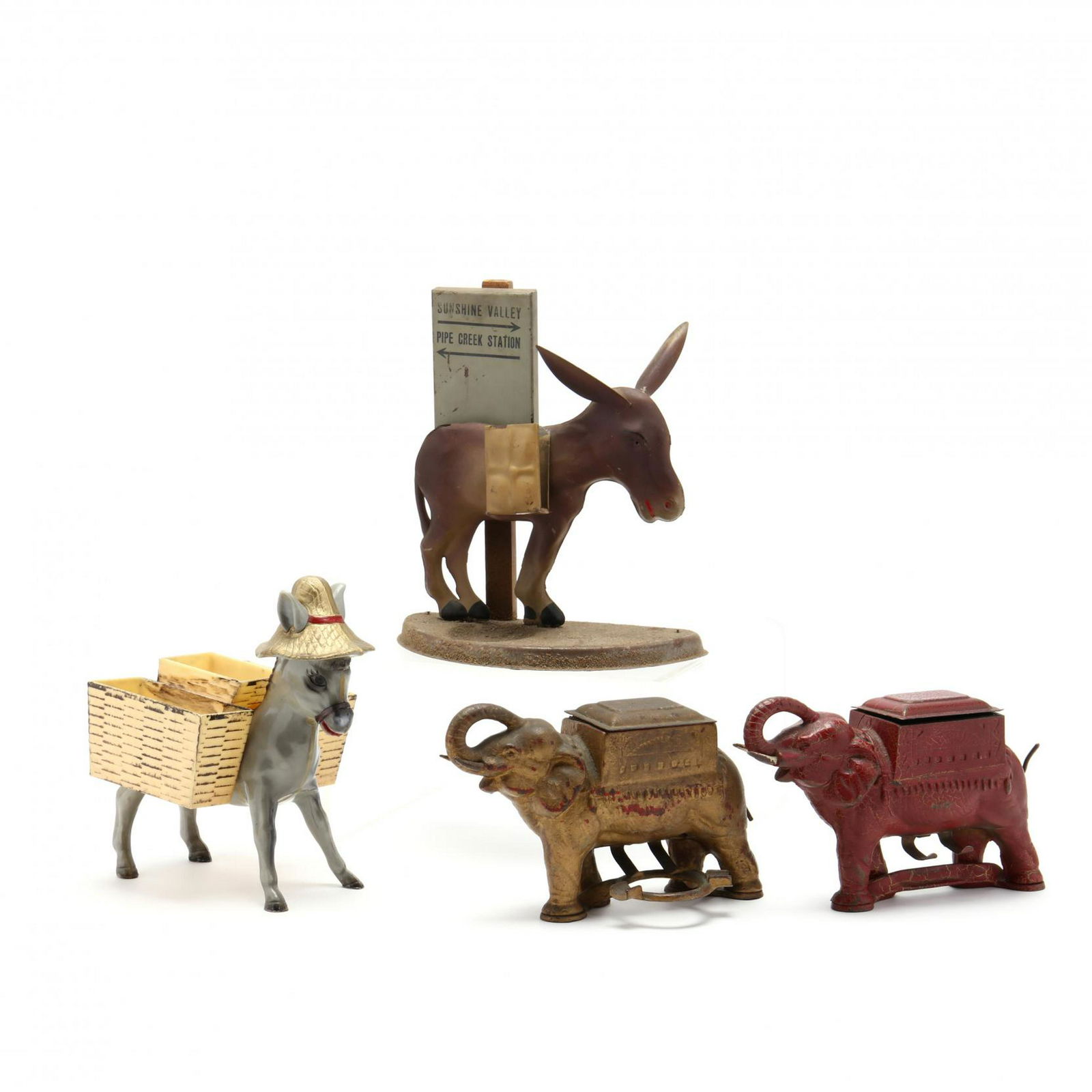 Two Cigarette Holders and Two Dispensers: Two Cigarette Holders and Two Dispenserscast metal mechanical elephant dispensers circa 1920s, one retains red paint (one lacks receiving tray); donkey form holders, a gray plastic one with side baske