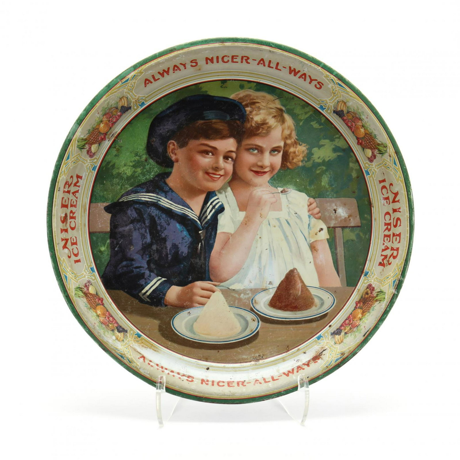 Vintage Niser Ice Cream Tin Litho Tray: Vintage Niser Ice Cream Tin Litho Tray early 1900s, a round tray depicting a young boy in sailor suit and girl savoring mounds of ice cream, "Always Nicer All-Ways" sayings encircle tray. 13.5 in. Fro