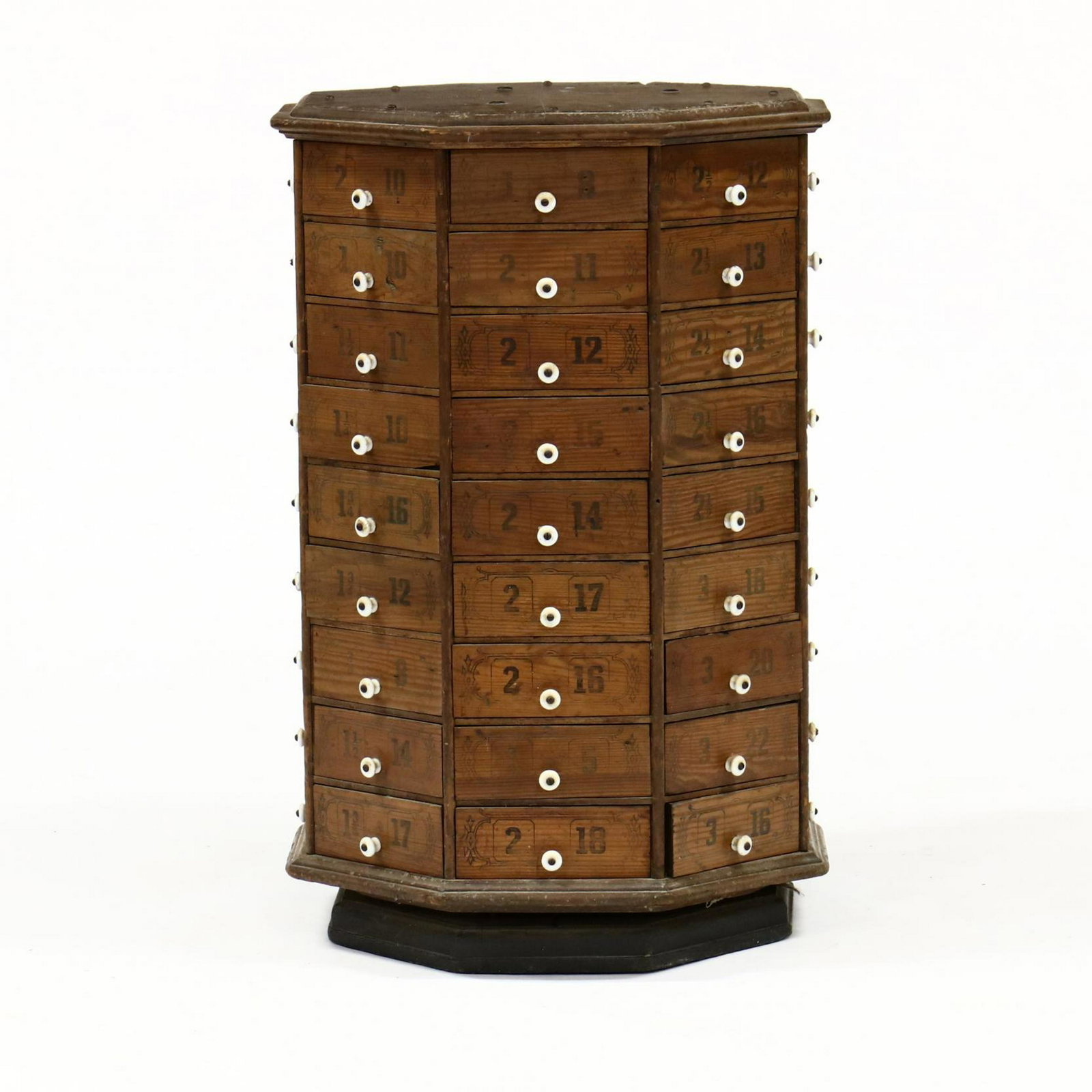 Antique Octagonal Rotating Spool Cabinet: Antique Octagonal Rotating Spool Cabinet late 19th century, pine case featuring (72) triangular drawers with pressed numbers on a recessed rotating base. 32 x 22 x 22 in. From the Collection of Mary W