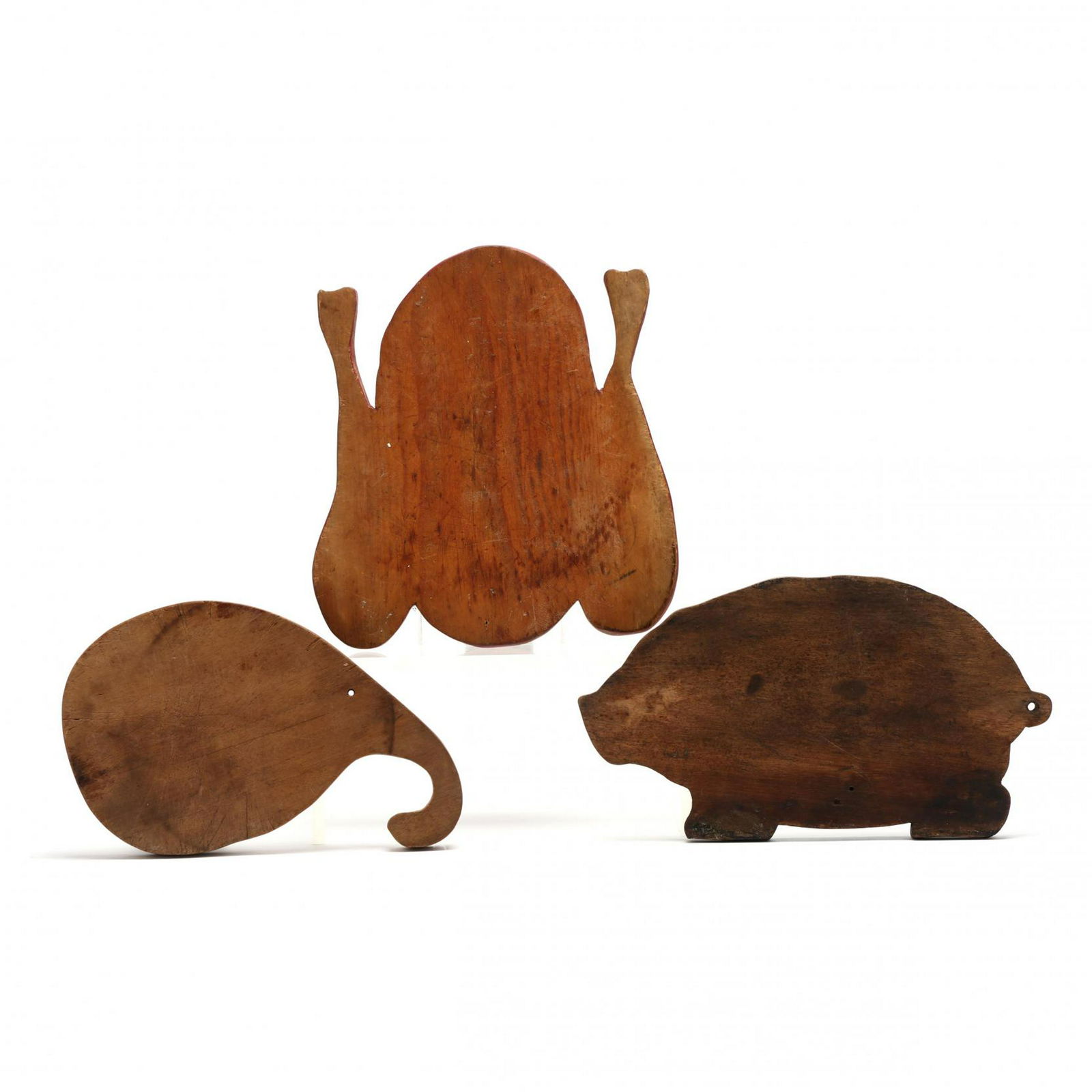 Three Hand-Made Cutting Boards: Three Hand-Made Cutting Boardsmid 20th century, wood in the shape of a turkey, a pig, a gourd. Turkey 11.5 x 10.25 in. From the Collection of Mary Wells, Greensboro, North Carolina Additional high-res