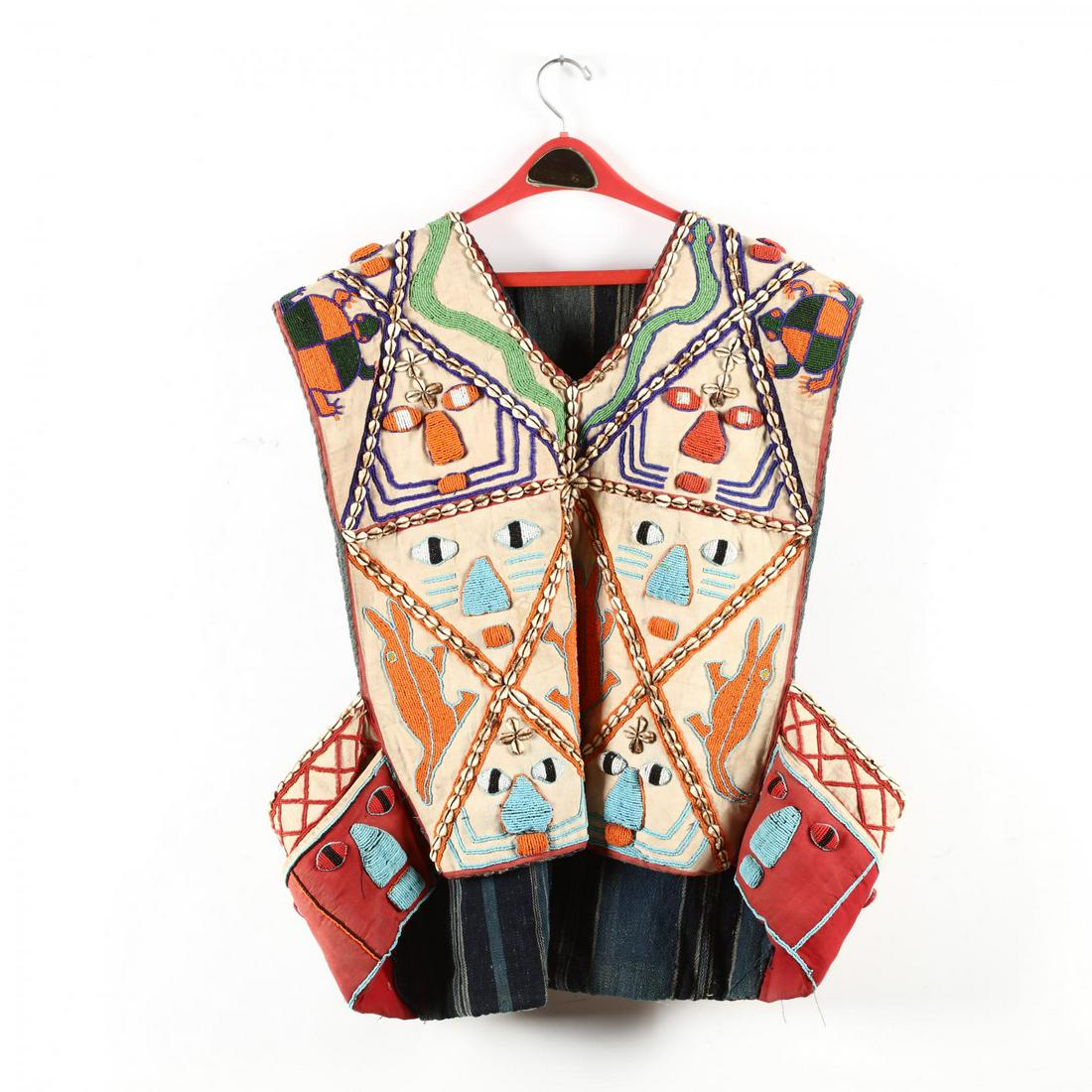 Nigeria, Yoruba Beaded Vest: Nigeria, Yoruba Beaded Vest linen fabric decorated with raised beaded and cowrie images of crocodiles, faces, snakes and turtles; with pockets; wool lining. Large size, 29 x 32 in. Ex. Collection of D