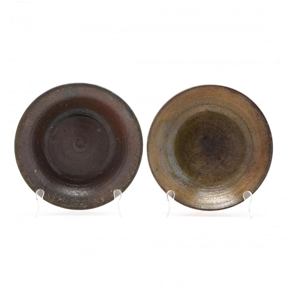Two Alamance County, NC., Dirt Dishes: Two Alamance County, NC., Dirt Dishes 19th century, earthenware with outwardly curved rim, the brown glazed dish ha an applied slip at the rim which may have once been yellow in color. 2.25 x 9.75 in.