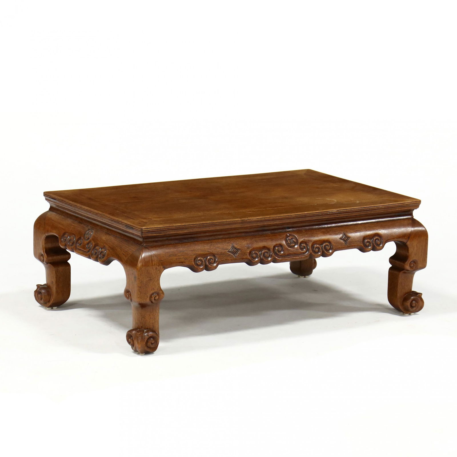 Chinese Low Carved Hardwood Tea Table: Chinese Low Carved Hardwood Tea Table20th century, rectangular form, relief carved scrolled skirt raised on paw feet. 13 x 31 x 21 in. Additional high-resolution photos are available at LelandLittle.