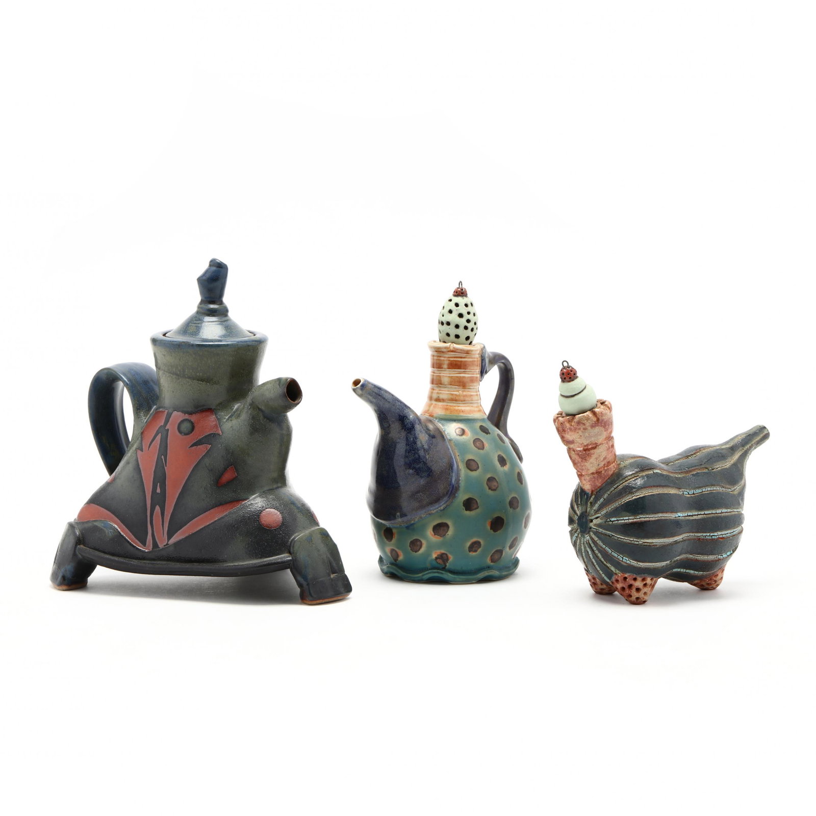 Three Studio Pottery Teapots: Three Studio Pottery Teapots molded and turned, imaginative forms, with stoppers, unsigned but clearly by the same artist, attributed to Nick Joerling, associated with the Penland School of Crafts. La