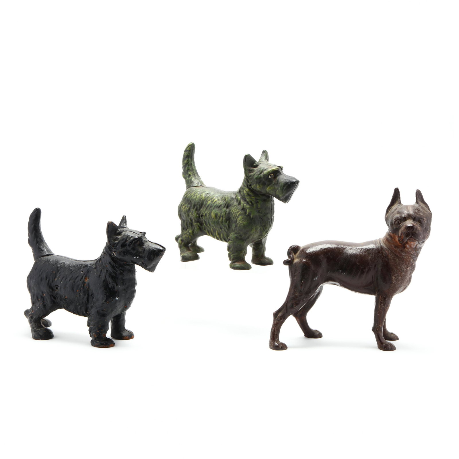 Three Iron Dog Form Doorstops: Three Iron Dog Form Doorstops including an early 20th century painted Boston terrier and two late 20th century wire haired terriers. Tallest 10 in. From the Collection of Joe Rowand, Chapel Hill, NC A