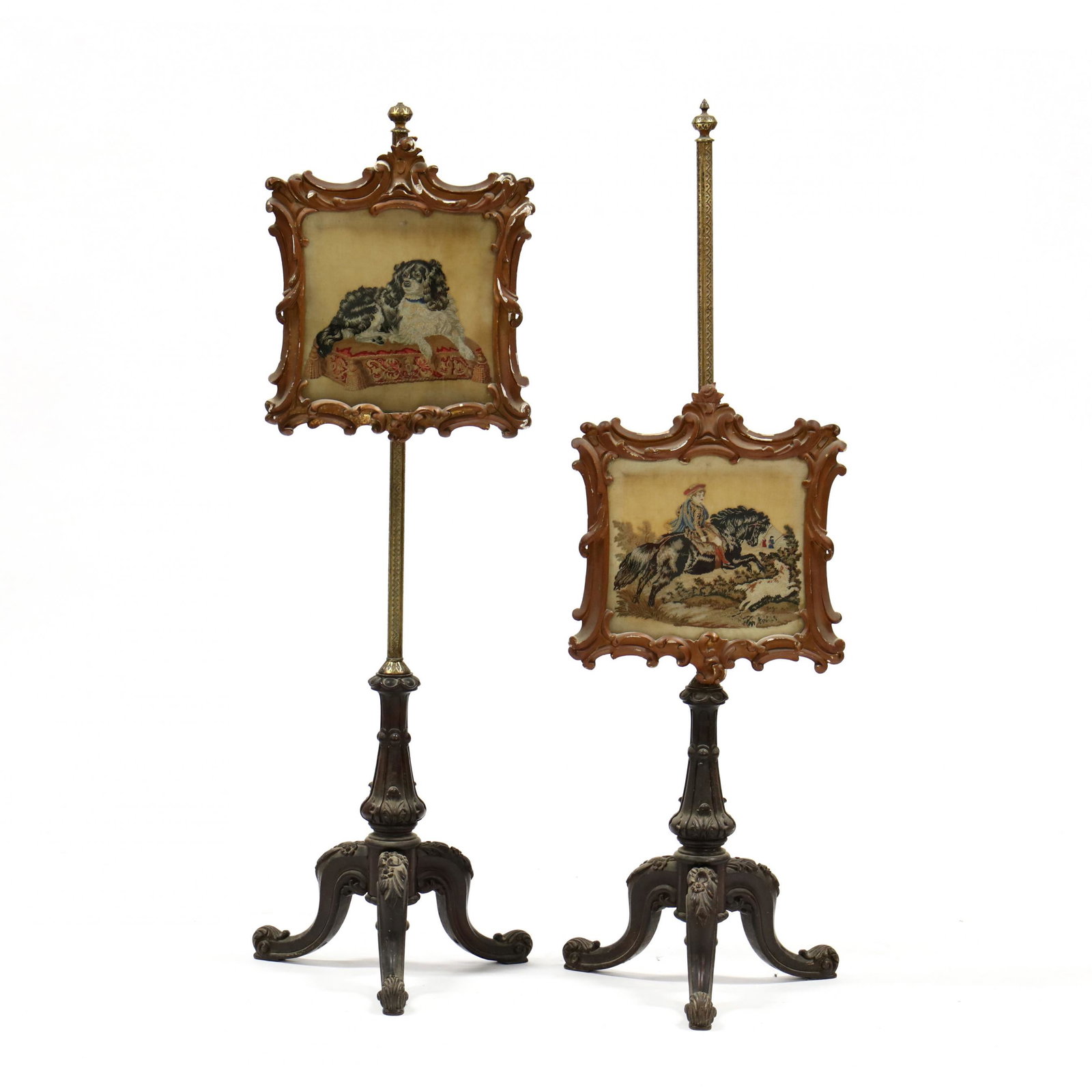 Pair of Rococo Style Carved Rosewood Polescreens: Pair of Rococo Style Carved Rosewood Polescreens circa 1860, gilt and engraved metal poles with adjustable needlepoint spaniels on pillows with a carved and gilt frame, under glass, tripod base of car