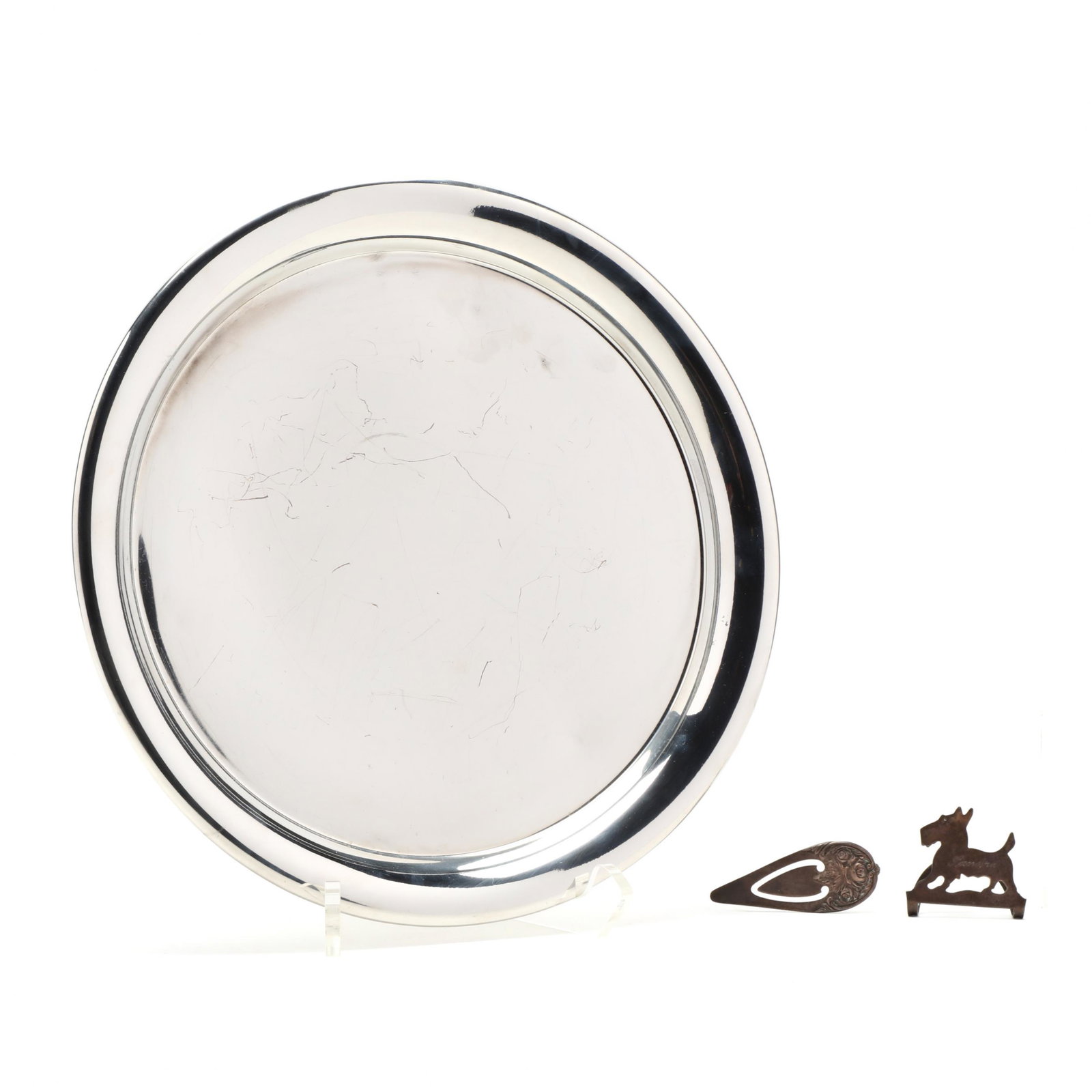 Cartier Pewter Tray & Two Sterling Silver Novelties: Cartier Pewter Tray & Two Sterling Silver Novelties the circular tray marked and in the original presentation box, no monogram (10.75 in. diameter) (some denting and scratching); a scottie form napkin