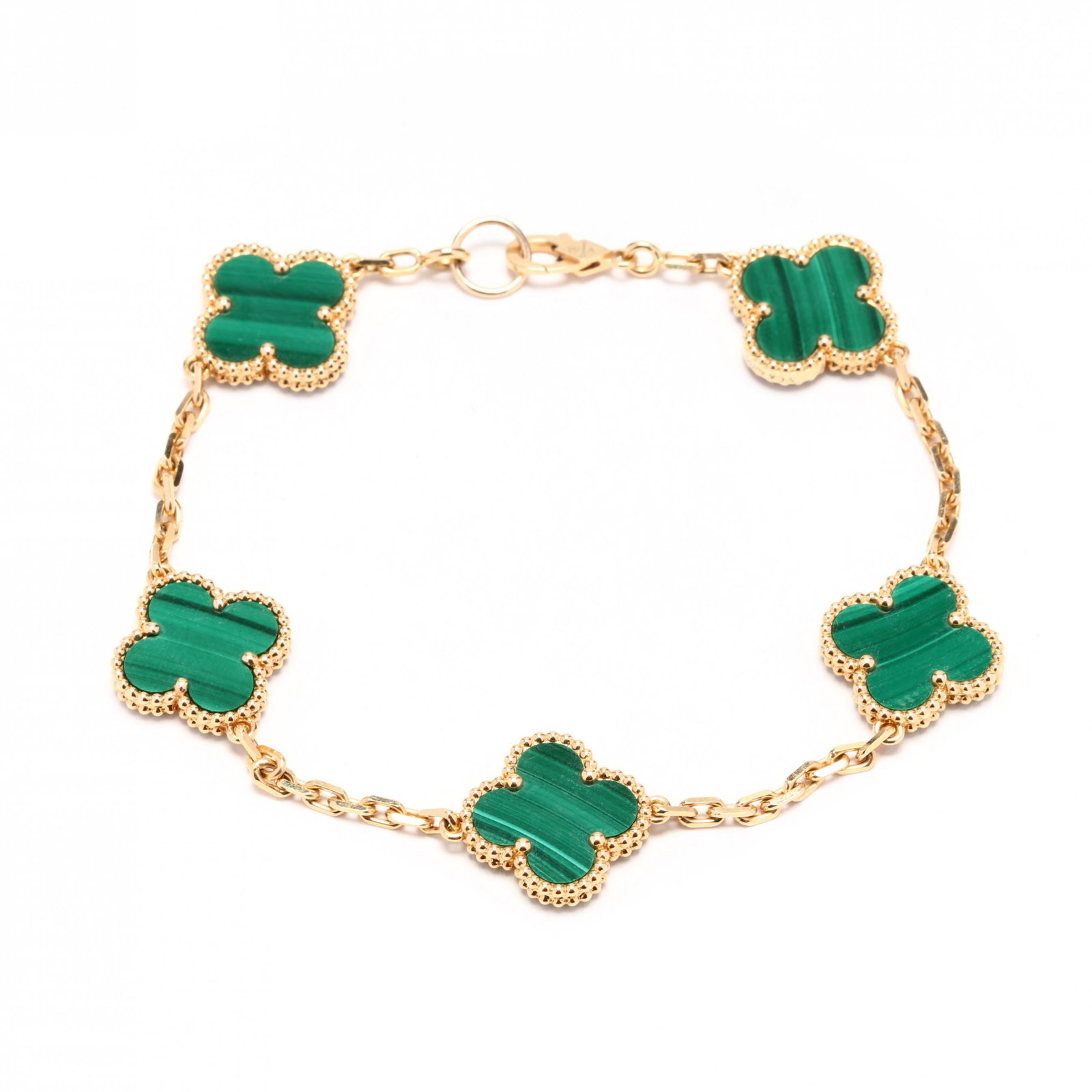 18KT Gold and Malachite "Alhambra" Bracelet, Van Cleef: 18KT Gold and Malachite "Alhambra" Bracelet, Van Cleef & Arpelsthe five malachite motifs carved in a clover leaf form with bead detailing to gold frames, completed with lobster clasp marked S612 / VC&