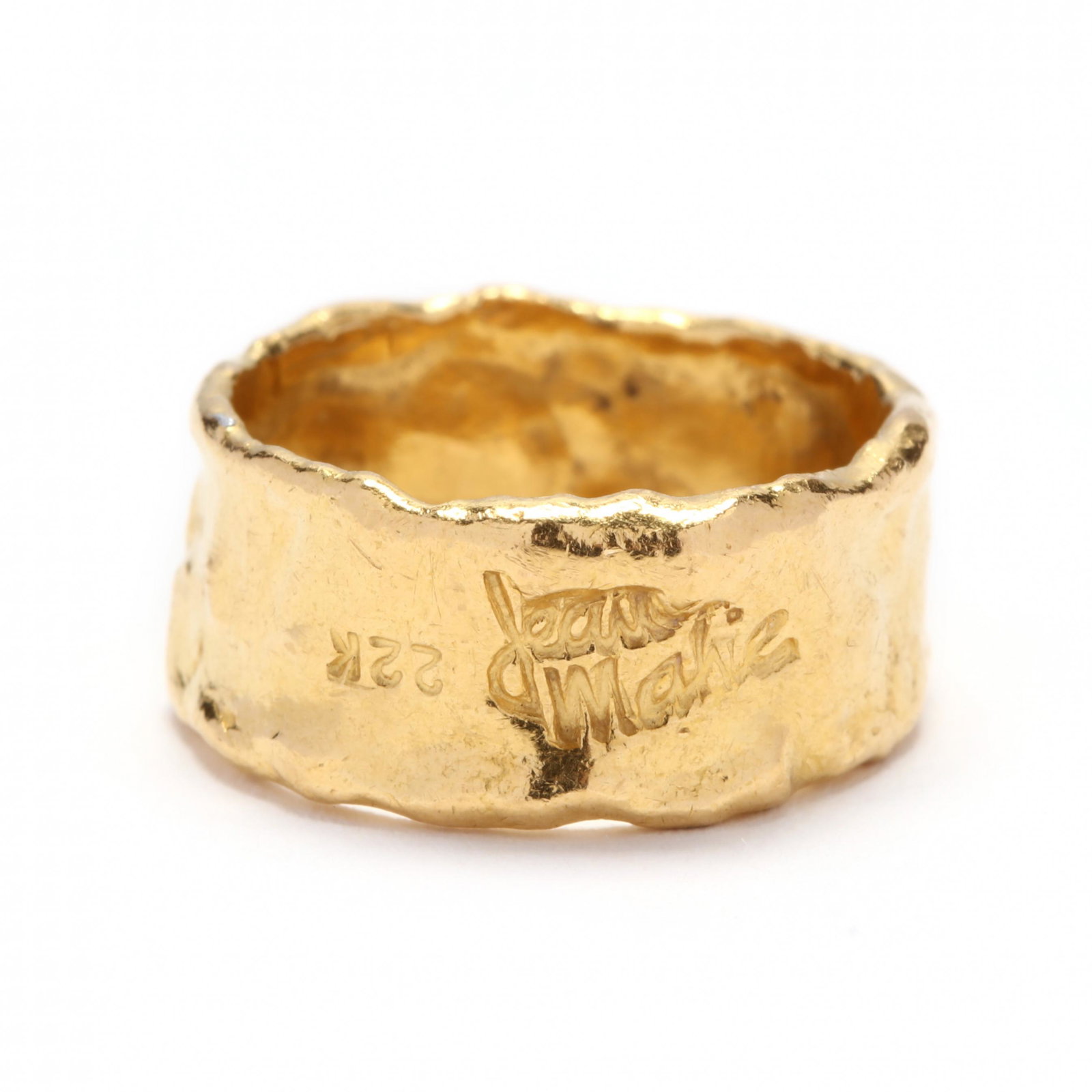 22KT Gold Band, Jean Mahie: 22KT Gold Band, Jean Mahie band designed in free form of hammered yellow gold and signed to the front and stamped 22K. 8.5mm; Ring size 6 5.1 dwt. Additional high-resolution photos are available at Le