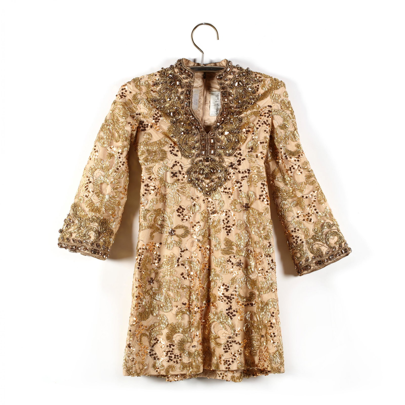 George Halley, Beaded and Jeweled Tunic Dress: George Halley, Beaded and Jeweled Tunic Dress late 1960s, for Bergdorf Goodman, peach tone lining with mesh overlay having gold bead, sequin, rope trim, and rhinestones of varying sizes, V neck with n
