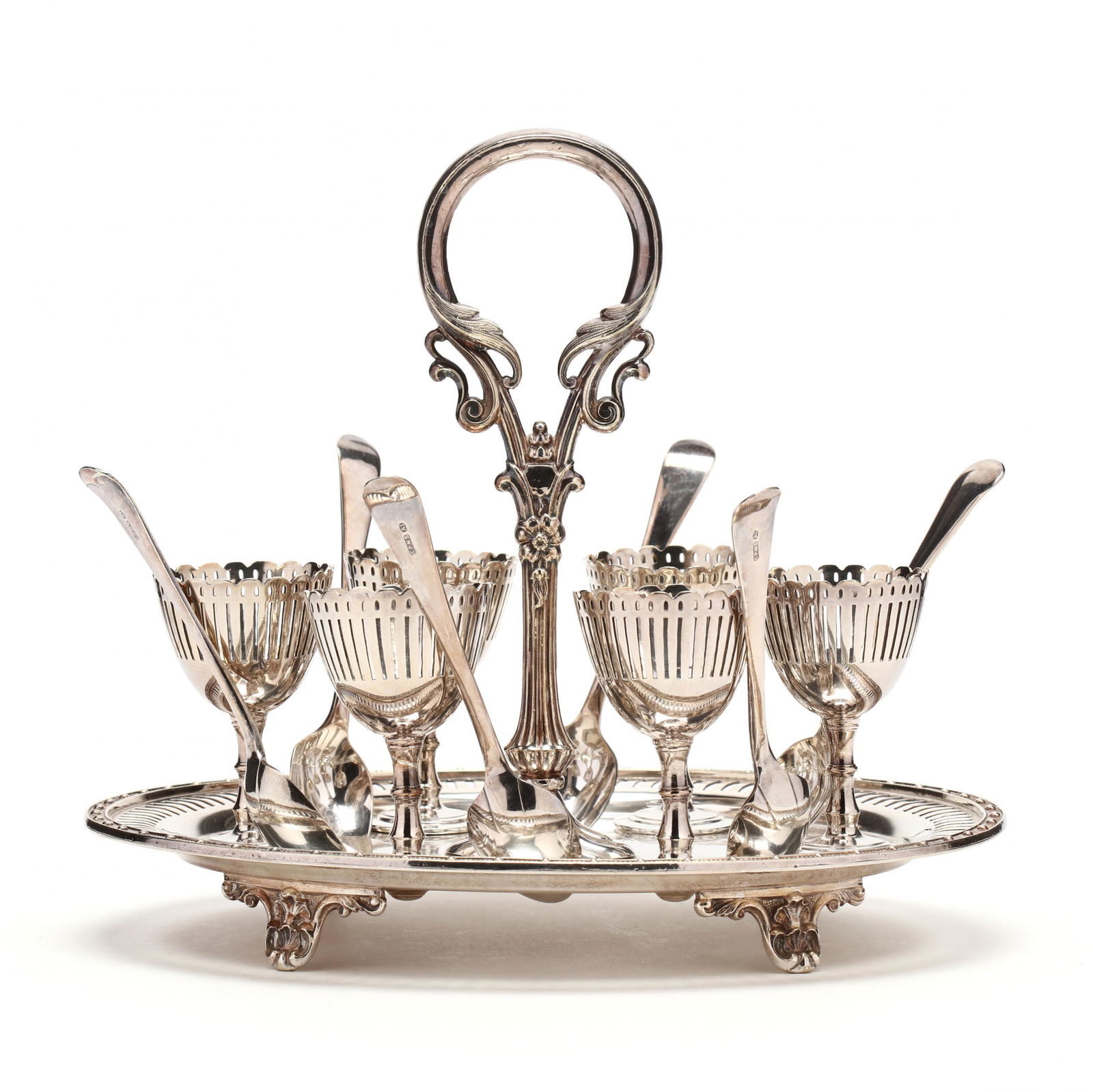 Victorian Silverplate Egg Stand: Victorian Silverplate Egg Standlate 19th century, with six egg stands and six spoons, the oval stand and the egg cups with reticulated decoration. LOA 9.25 in. Private Collection, Nashville, Tennessee