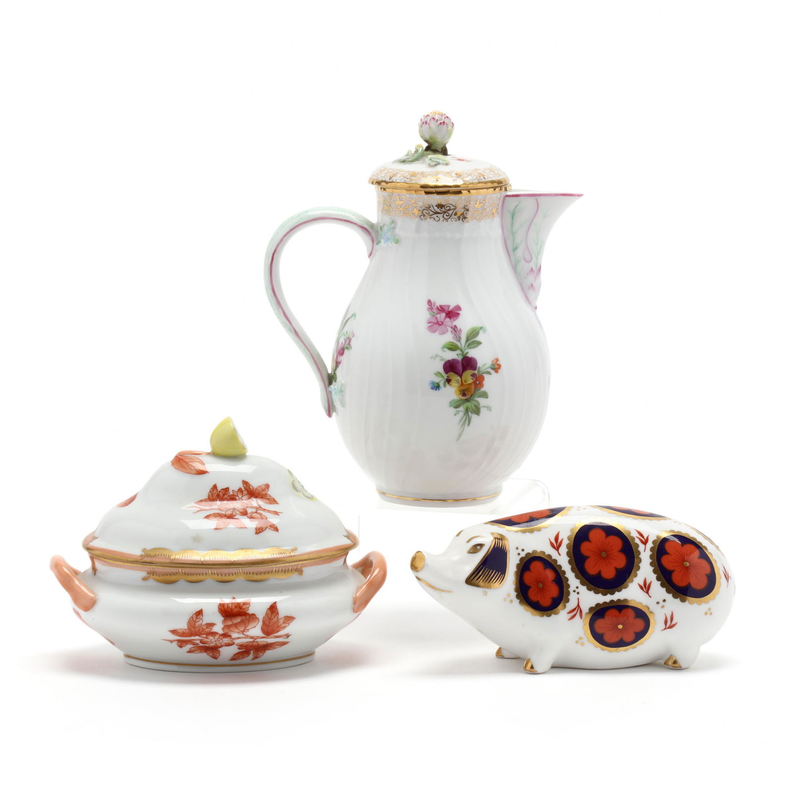 Three Fine Porcelains: Three Fine Porcelainsincluding a Herend lidded small serving dish in rust with lemon finial; a KPM porcelain cream pitcher with lid; and a Royal Crown Derby Imari pattern pig, each marked. Tallest 6 i