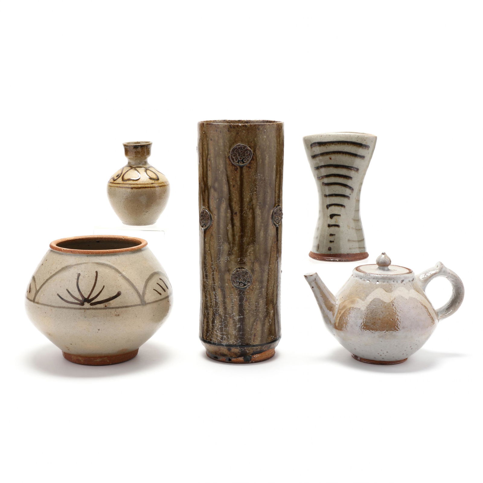 A Group of Mark Hewitt Pottery by Apprentices: A Group of Mark Hewitt Pottery by Apprenticeswood-fired salt glazed, five pieces: two vases, a footed low vase, a teapot, a tall cylindrical vase. 11.75 in. Collection of John Davis, Durham, North Car