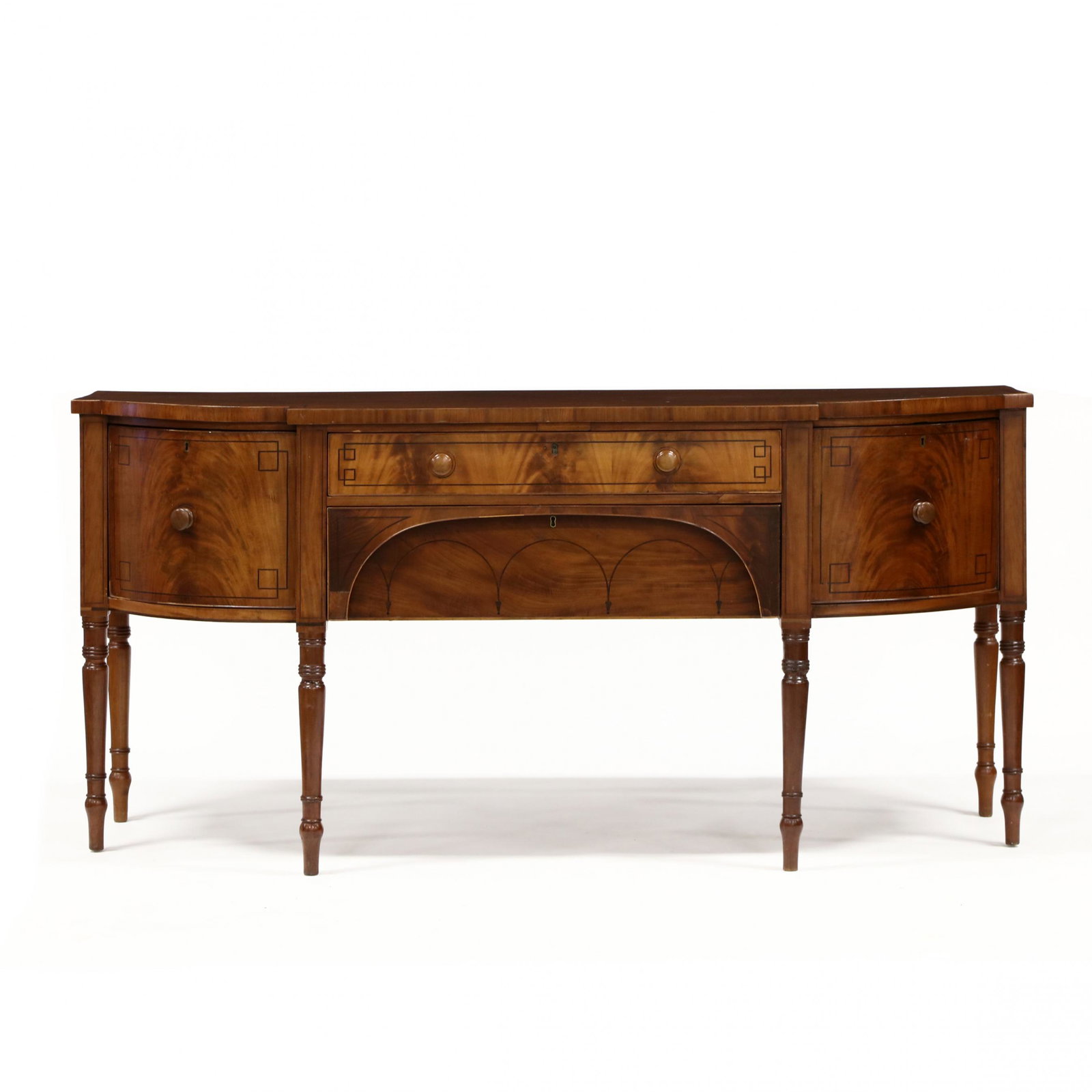 English Sheraton Inlaid Mahogany Sideboard: English Sheraton Inlaid Mahogany Sideboard 19th century, oak and pine secondary, bow front form, top with banded inlay, case with four drawers featuring geometric banded inlays, raised on turned legs.