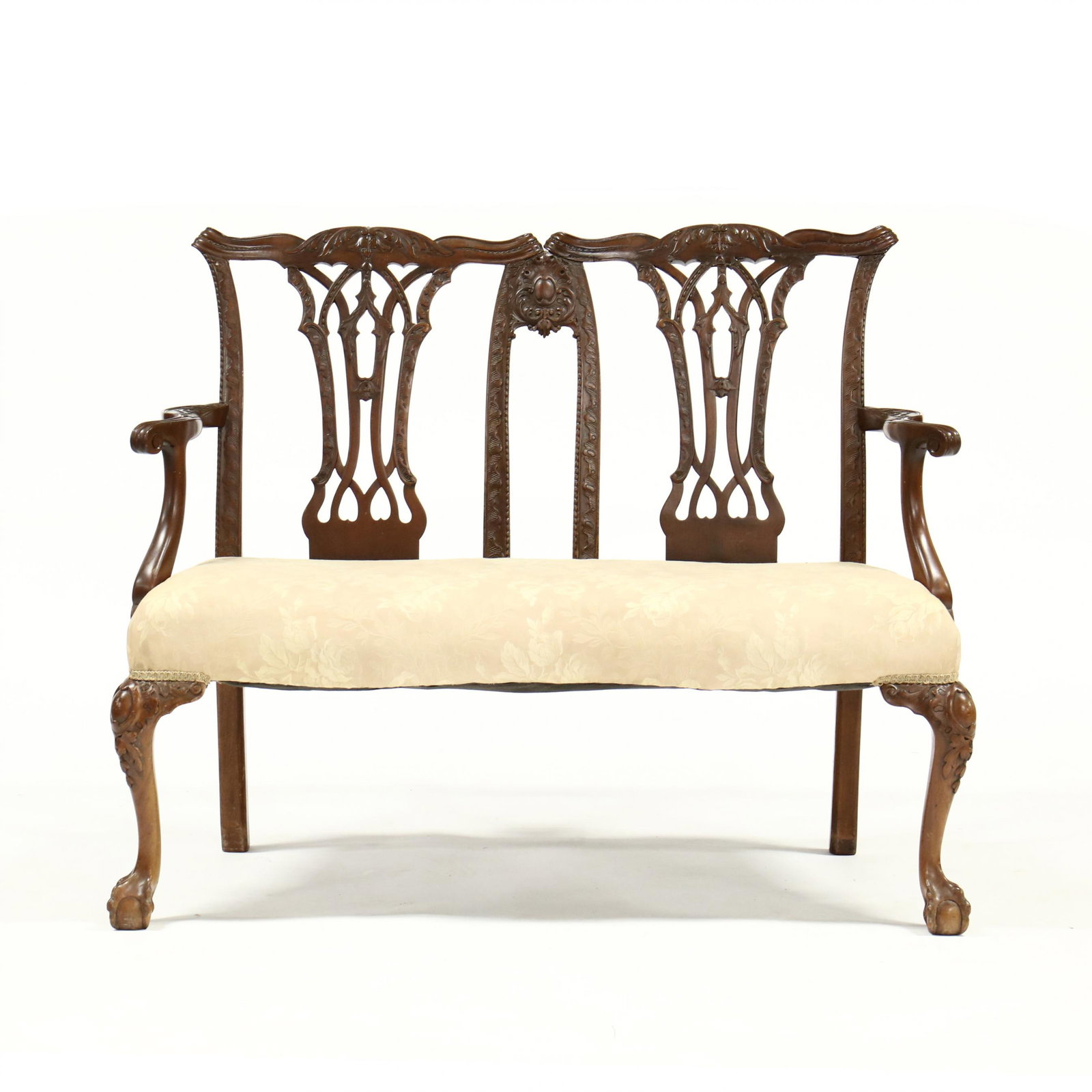 English Chippendale Style Mahogany Settee: English Chippendale Style Mahogany Settee circa 1900, relief carved double seat with pierced backsplat, shaped and relief carved arms with scrolled knuckle, upholstered seat with serpentine front, fro