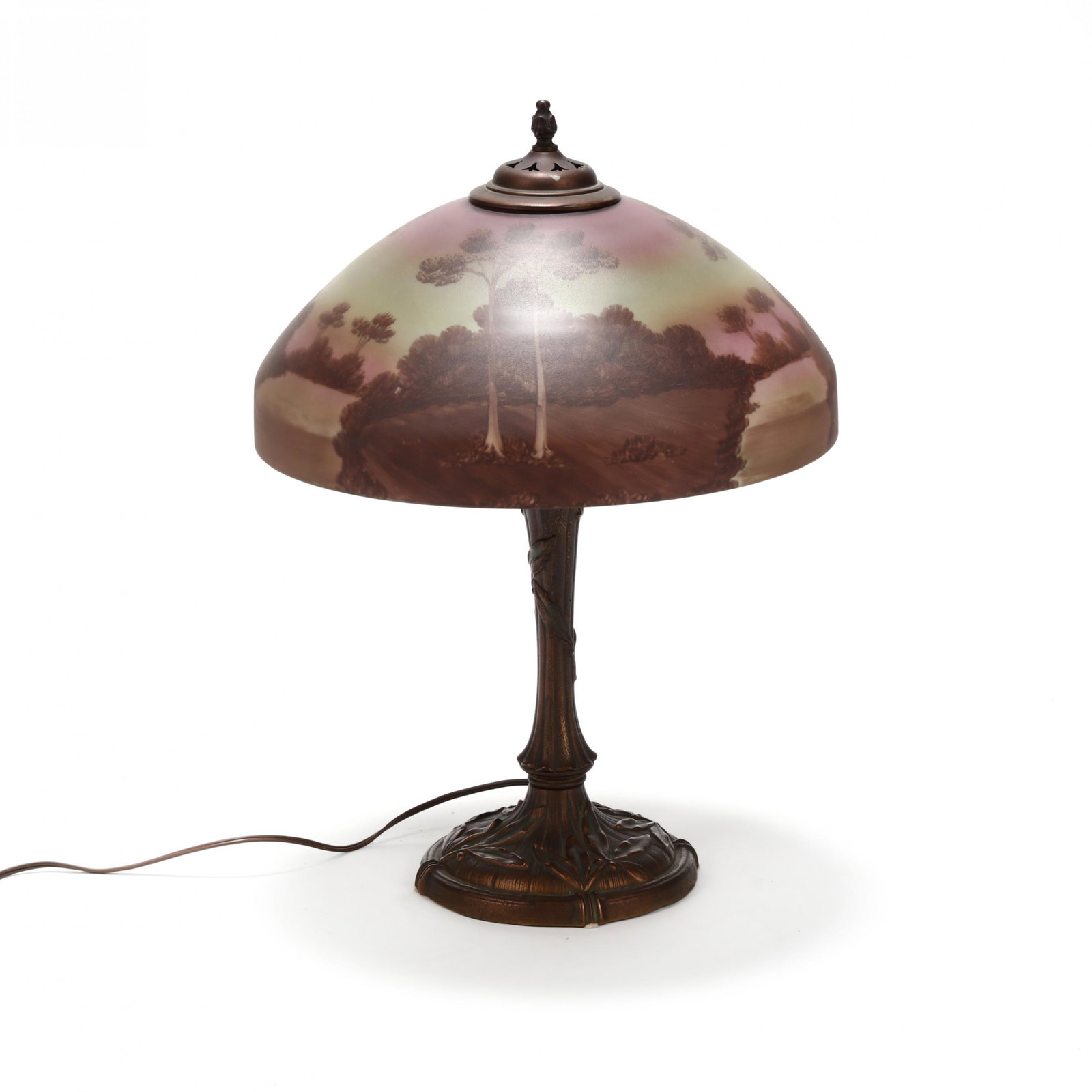 att. Pittsburg Reverse Painted Landscape Table Lamp: att. Pittsburg Reverse Painted Landscape Table Lamp unsigned, with sunset tree lined shoreline landscape, on a period holly leaf base with copper finish. HOA 22.5 in. From the Collection of Colonel an
