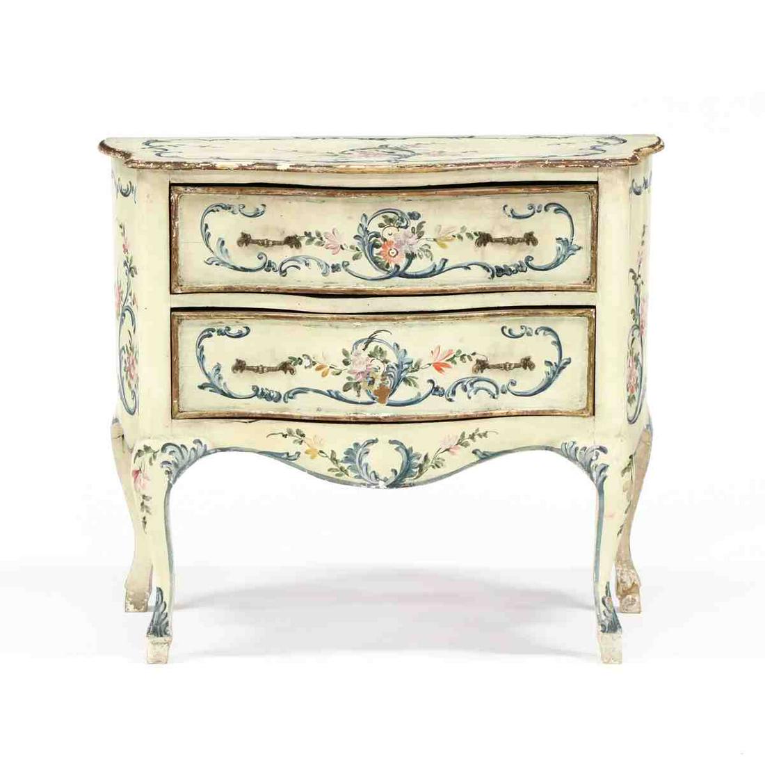 Vintage Italianate Diminutive Painted Commode: Vintage Italianate Diminutive Painted Commode mid 20th century, serpentine-form, cream painted surface with scroll and foliate sprays, case with two drawers, raised on cabriole legs. 31.5 x 36 x 17 in