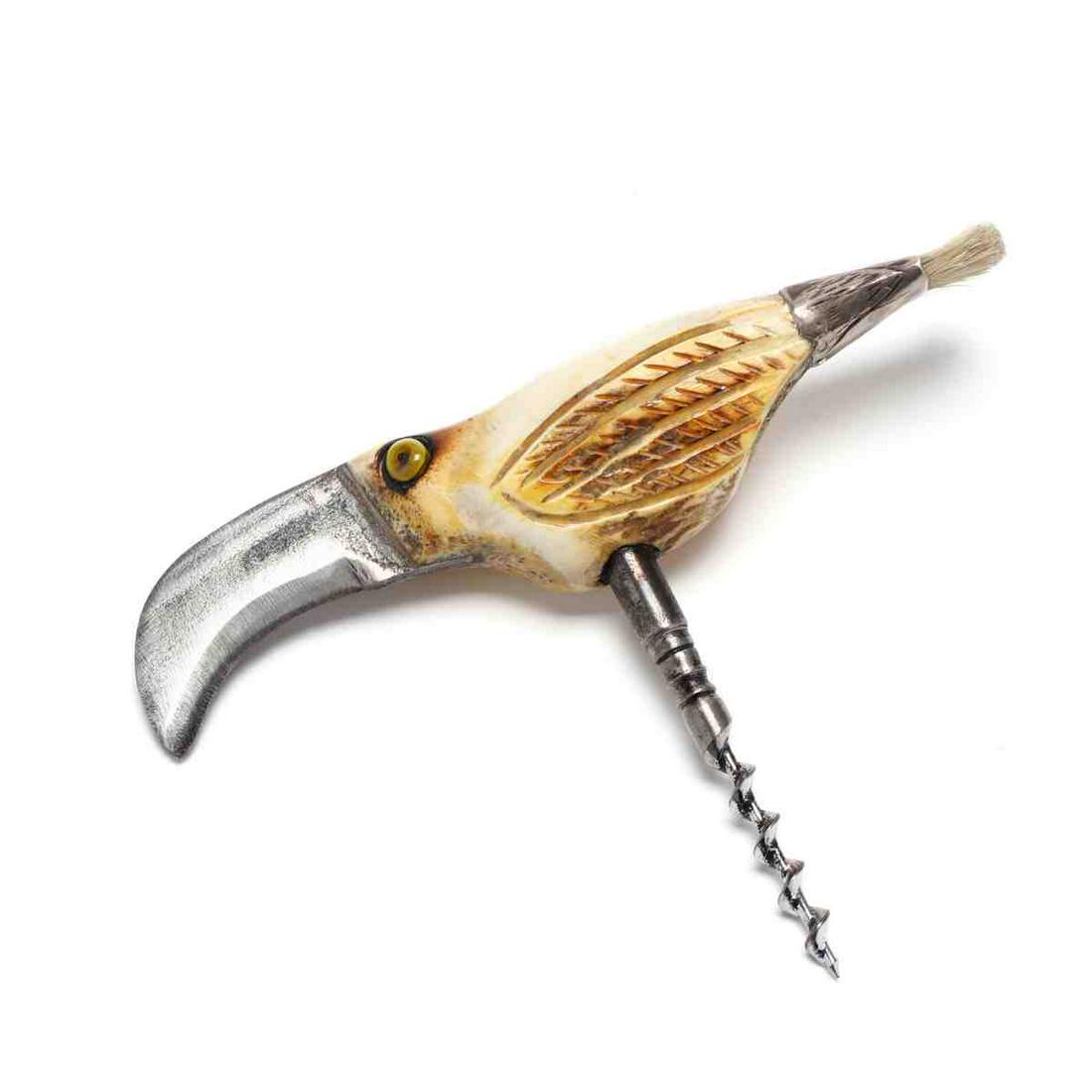 Carved Antler and Sterling Silver Corkscrew: Carved Antler and Sterling Silver Corkscrew carved in the form of a toucan with inset painted eyes, blade form beak and marked silver ferrule with bottle brush tail. Length 6.75 in. Private Collection