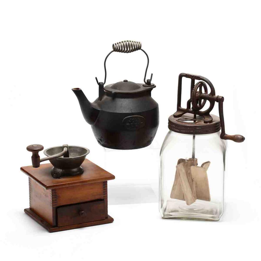 Three Antique Kitchen Tools: Three Antique Kitchen Toolsthe first an antique burr coffee grinder; the second a John Wright cast iron kettle; and the third a six quart glass butter churn with wooden paddle (15.25 in.). Private Col