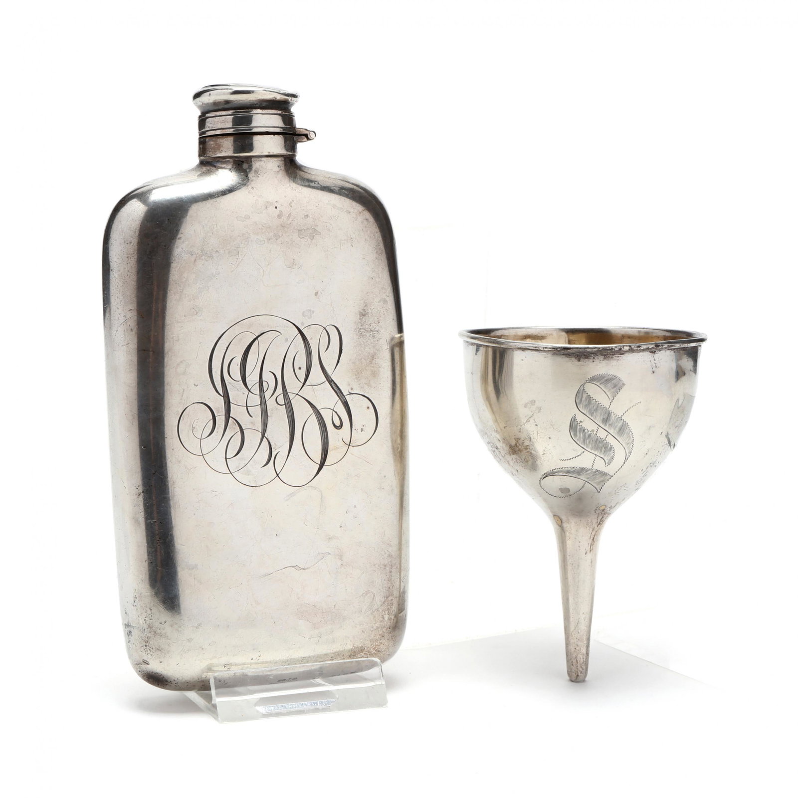 An Antique Sterling Silver Flask and Funnel: An Antique Sterling Silver Flask and Funnel the flask with mark of Gorham, 1/4 pint capacity, 1898 date symbol, period script monogram "SJBS" (some denting and scratching); the funnel by unknown manuf