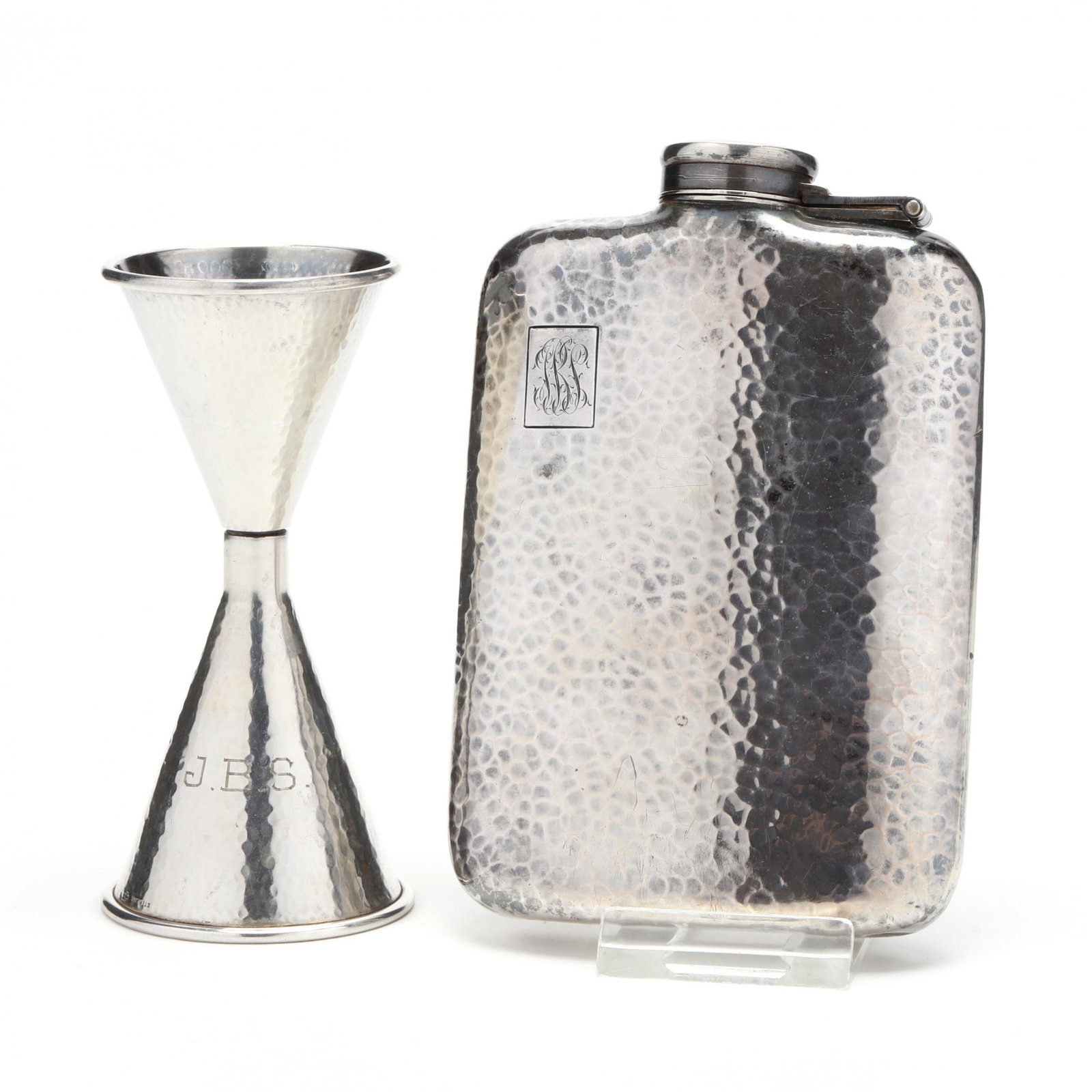 Sterling Silver Jigger and .950 Fine Silver Flask: Sterling Silver Jigger and .950 Fine Silver Flask both with hand-hammered finish; the flask made in Japan and with period script monogram "SJBS" (5 x 3 1/8 in.) (light scratching); the jigger of unkno