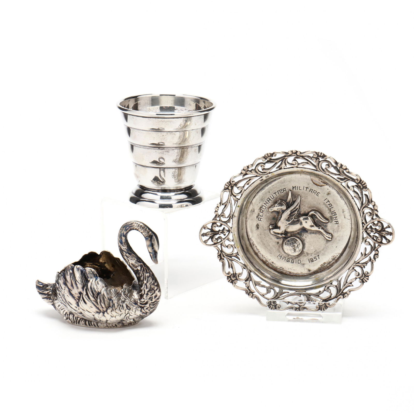 Three Vintage Silver Bar Accessories: Three Vintage Silver Bar Accessoriesincluding a sterling silver shot glass (2.25 in.); a German .800 silver swan form salt dish (LOA 3 in.); and an Italian .900 silver ash tray with pegasus flying ove