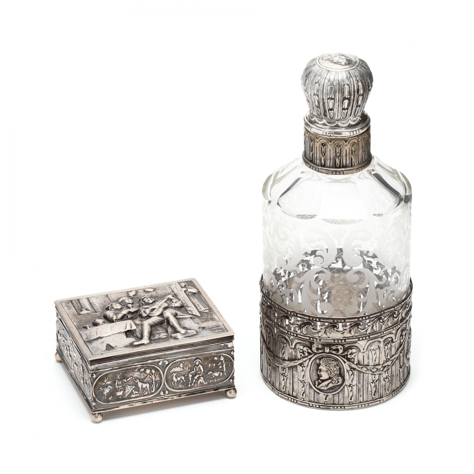 Two Continental Silver Table Accessories, circa 1900: Two Continental Silver Table Accessories, circa 1900the first a Dutch 2nd standard silver box with hallmarks, the hinged cover featuring a repousse tavern scene with musician and revelers, rectangular