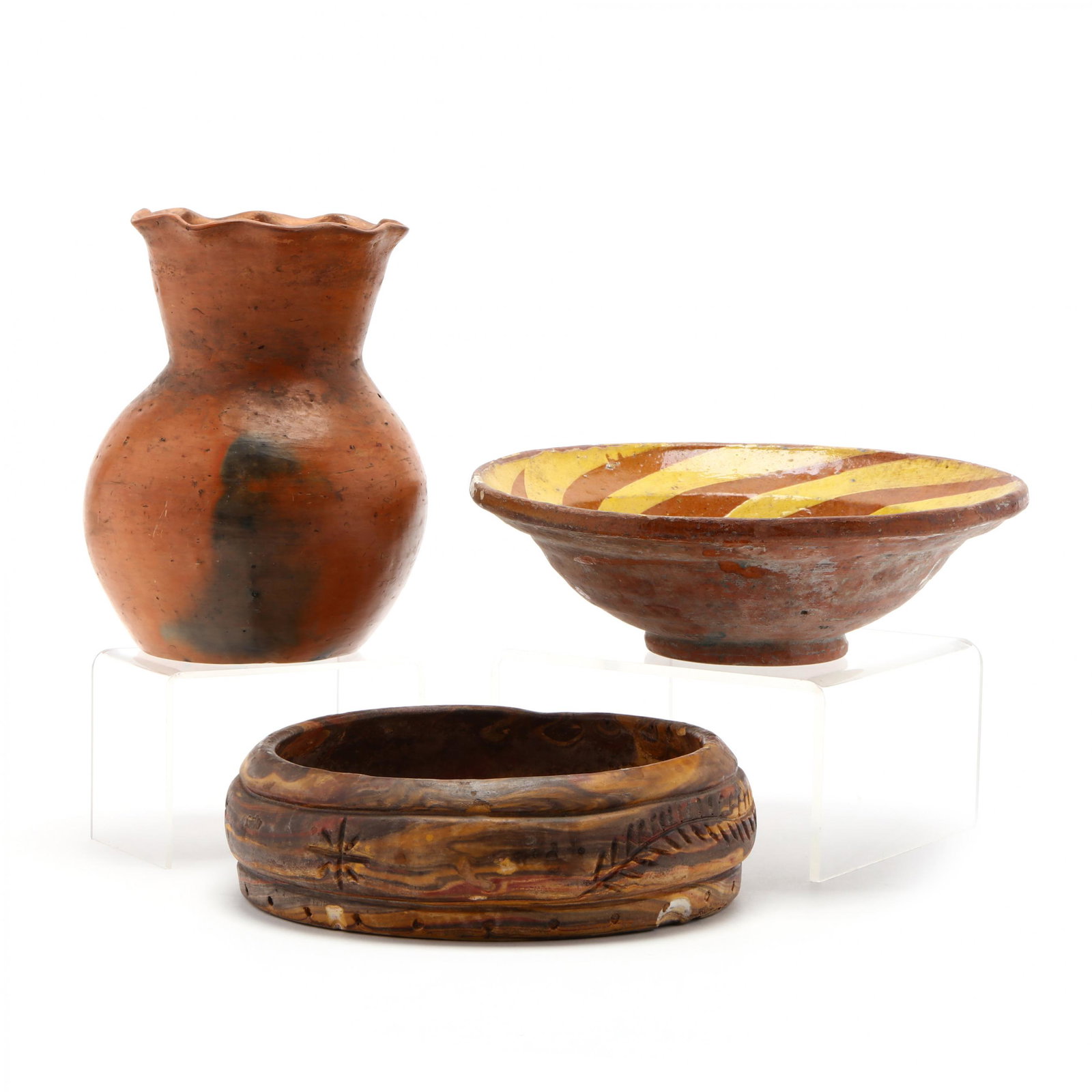 Three Earthenware Pottery Items: Three Earthenware Pottery Items a Catawba Indian ruffled rim burnished vase (rim hairline) (7 in.); a swirl clay low bowl with incised leaf design (2.5 x 8.5 in.) (rim and base chip); an antique slip 