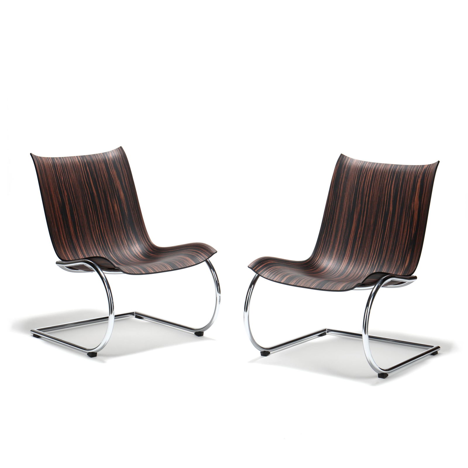 Peter Karpf (Denmark, b.1940), Pair of Agitari Lounge: Peter Karpf (Denmark, b.1940), Pair of Agitari Lounge Chairscontemporary, designed for Fredericia Furniture, Freiswinger polished steel frame, zebra wood shaped seat, with label. 30 x 21 x 25 in. Add