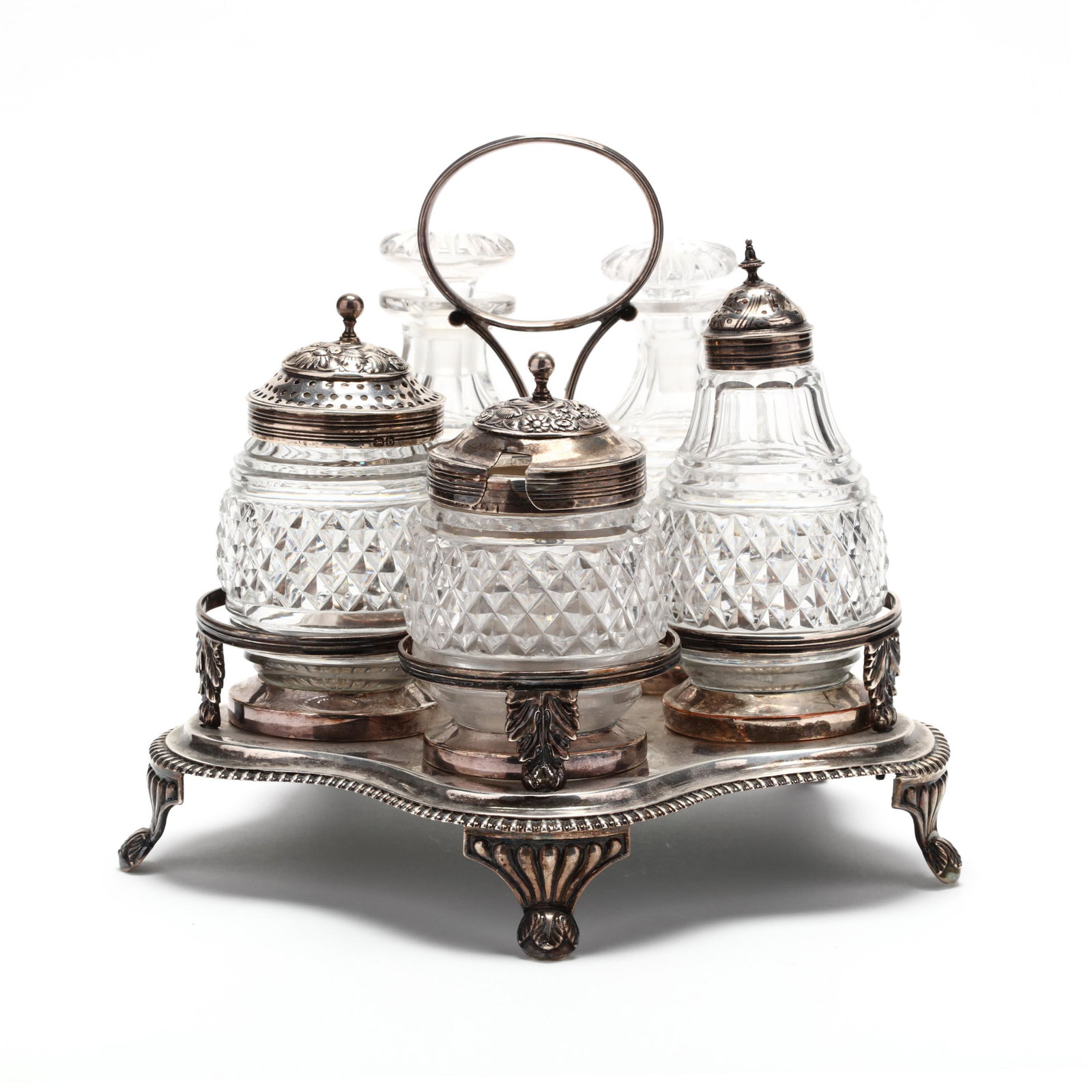 A George III Silver Cruet Set: A George III Silver Cruet Set the stand with mark of Rebecca Emes and Edward Barnard I, London (1813), shaped base with gadrooning to edge, raised on four bracket feet with acanthus motifs; the stand 