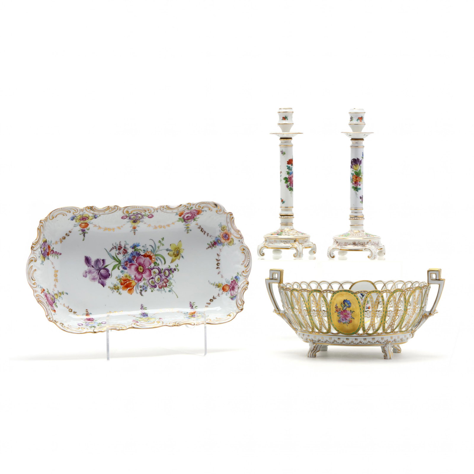 Three Decorative Dresden Porcelain Table Accessories: Three Decorative Dresden Porcelain Table Accessorieslate 19th century, painted with floral motif and gilt highlights, to include a pair of candlesticks with integral bobeche; a reticulated fruit baske