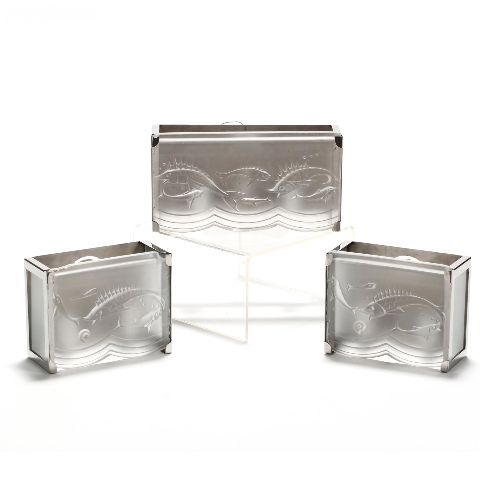 Three Art Deco Style Sconces: Three Art Deco Style Sconces late 20th century, frosted glass in polished steel mounts, each with a relief dolphin theme, scalloped lower edge, including one long double-light fixture and a pair of sm