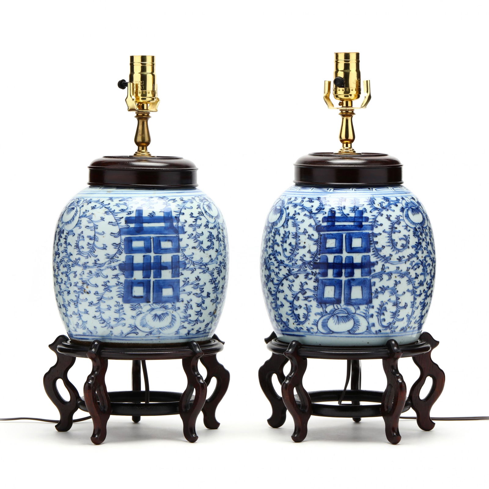 A Pair of Chinese Blue and White Double Happiness Lamps: A Pair of Chinese Blue and White Double Happiness Lamps20th century, two porcelain ginger jars hand painted in underglaze blue with double happiness symbols over a peony scrolling vine ground, drilled