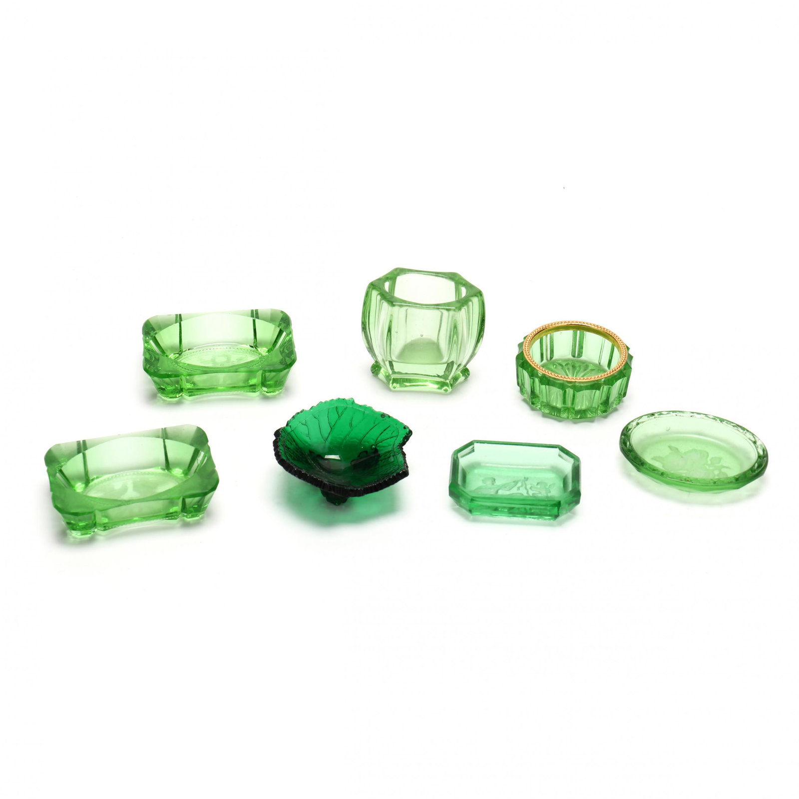 Seven Vintage Green Glass Table Accessories: Seven Vintage Green Glass Table Accessories20th century, including (6) salts (some with etched decoration), and (1) toothpick receiver. Tallest 2 in. Additional high-resolution photos are available a