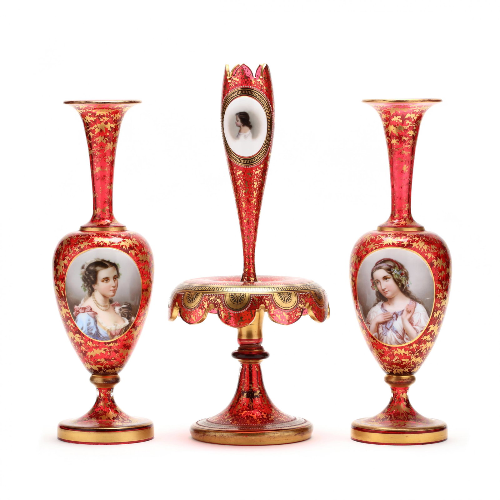 att. Moser, Three Piece Glass Portrait Garniture: att. Moser, Three Piece Glass Portrait Garniture 19th century, cranberry glass with all over gilt ivy and morning glory field, each with a raised cabochon with a hand-painted portrait of a beauty (one