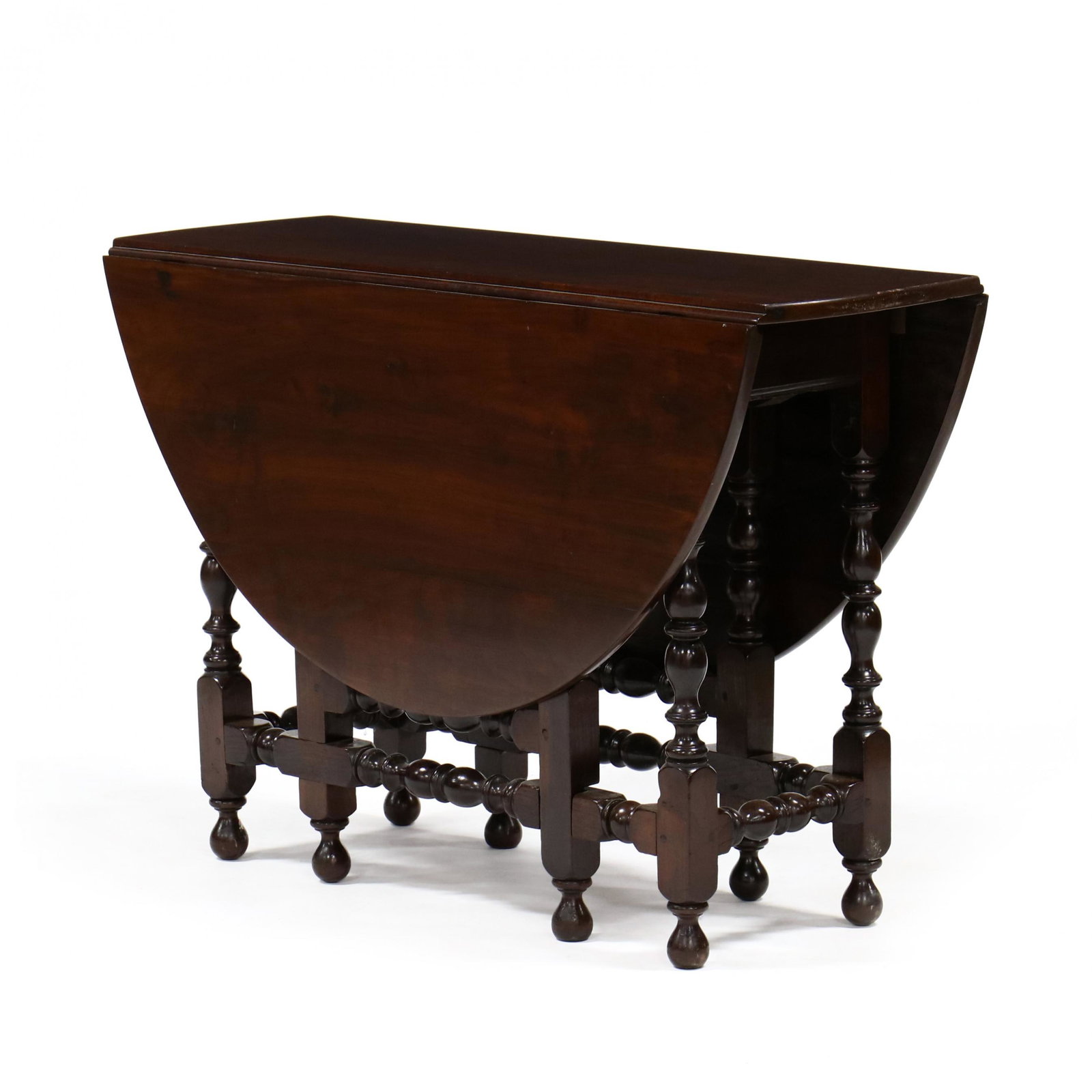 Late American Colonial Drop Leaf Dining Table: Late American Colonial Drop Leaf Dining Table circa 1800, walnut, yellow pine and poplar secondary, drop leaves with gateleg support, single flush long drawer raised on turned legs and stretcher base.