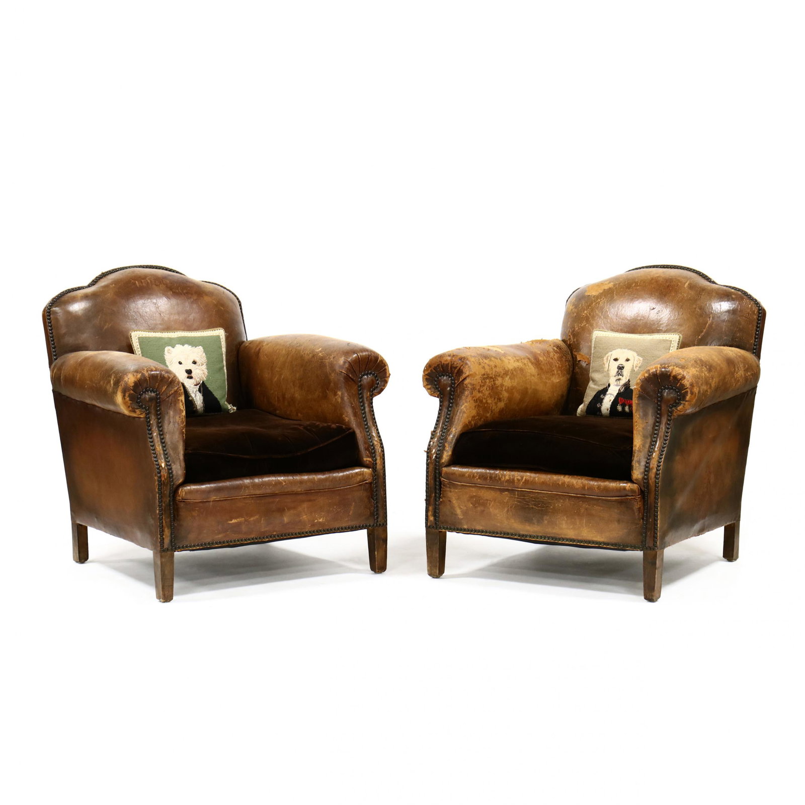 Pair of Vintage English Leather Club Chairs: Pair of Vintage English Leather Club Chairs circa 1920, original brown leather upholstery with brass nailhead trim, plush brown down-filled cushions, on square tapered feet. 33 x 33 x 33 in. From the 