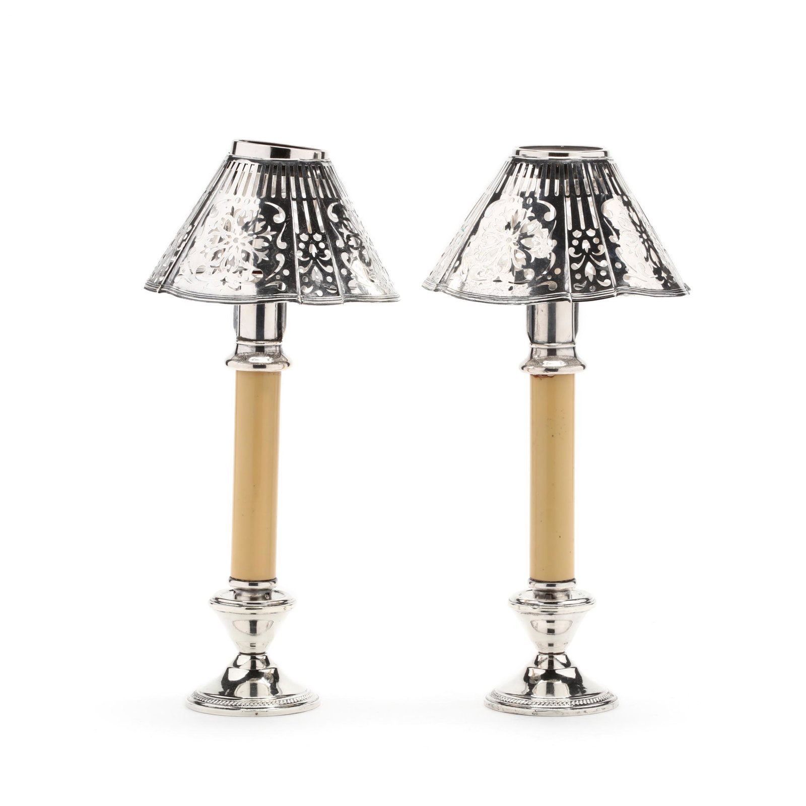 A Pair of Candlestick Lamps with Silverplate Shades: A Pair of Candlestick Lamps with Silverplate Shades sterling silver weighted base candlesticks hold a spring loaded candle shaft which supports a frame for a Gorham silverplate reticulated shade. HOA 